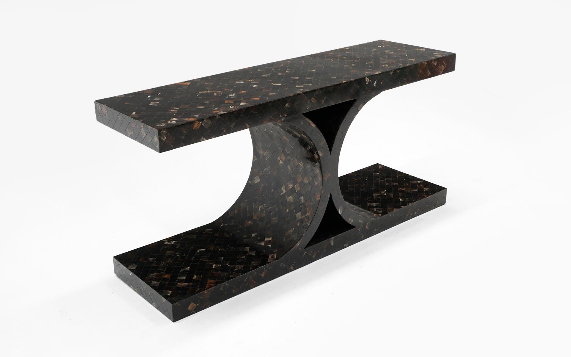 Karl Springer console / sofa / entry table. Sculptural form in tessellated horn inlay. Expertly restored and in very good to excellent condition. Sold with a digital certificate of authentication from Tom Langevin, former director of Karl Springer,