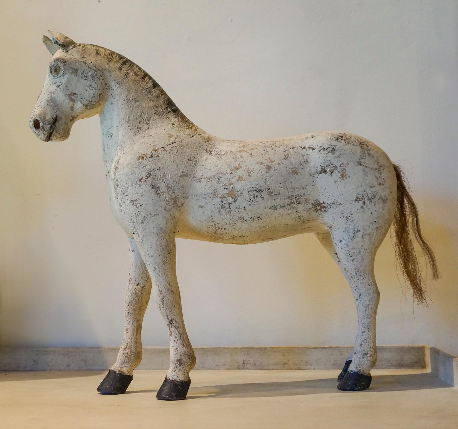 Carved toy horse, Sweden, circa 1880, with leather ears and horsehair tail. Original painted surface, including the mane and eyes. Alert expression suggests this boy is ready for a romp.