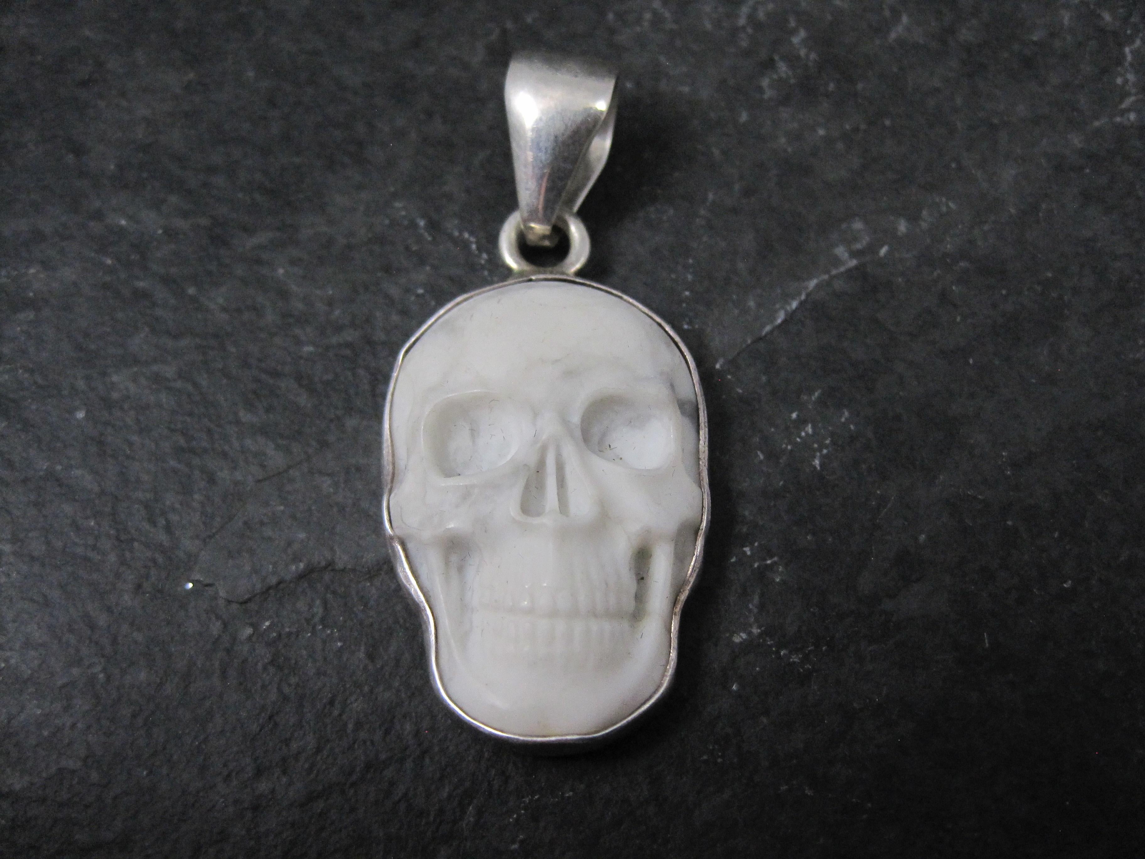 This gorgeous sterling silver pendant is a creation of Charles Albert.
It features a hand-carved howlite skull.

Measurements: 13/16 by 1 7/8 inches, including the bail
The bail will accommodate a chain up to 6mm wide.

Condition: Excellent
