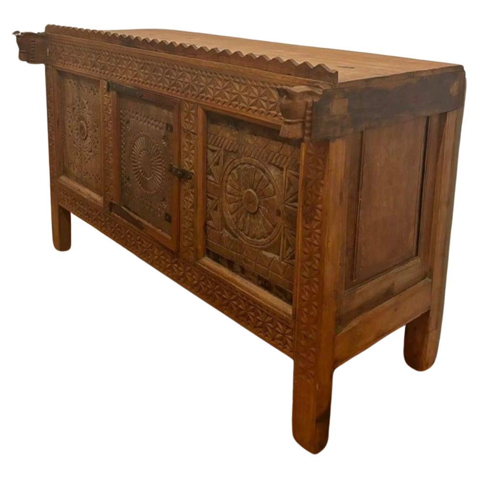 Fantastic and unique storage piece from India. Beautiful carved wood details throughout. 

Only the middle panel is designed to open. The side panels do not open. There are not shelves inside. It's essentially a blanket chest. 

Unknown origins.