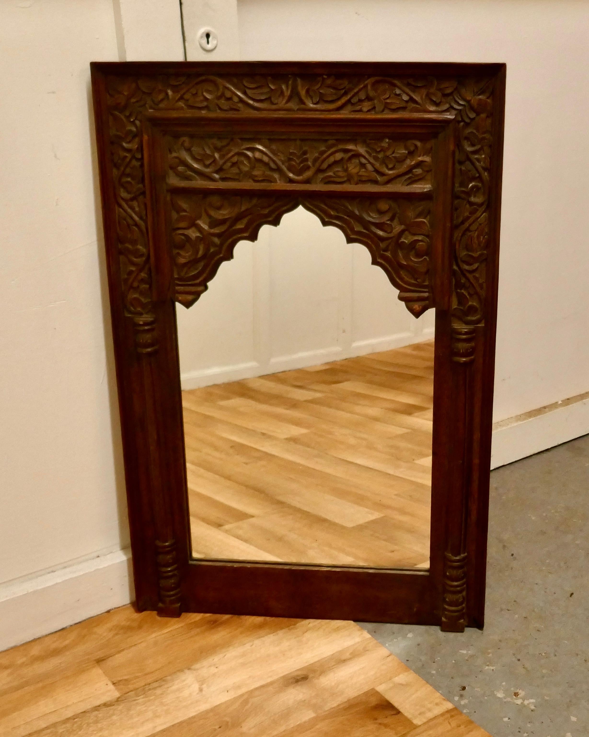 Carved Indian teak mirror

A lovely piece from the east, the wide frame is carved with leaves and fruits, the looking glass is new
A lovely piece with an Islamic look
The Mirror is 36” high and 24” wide
TAC139.