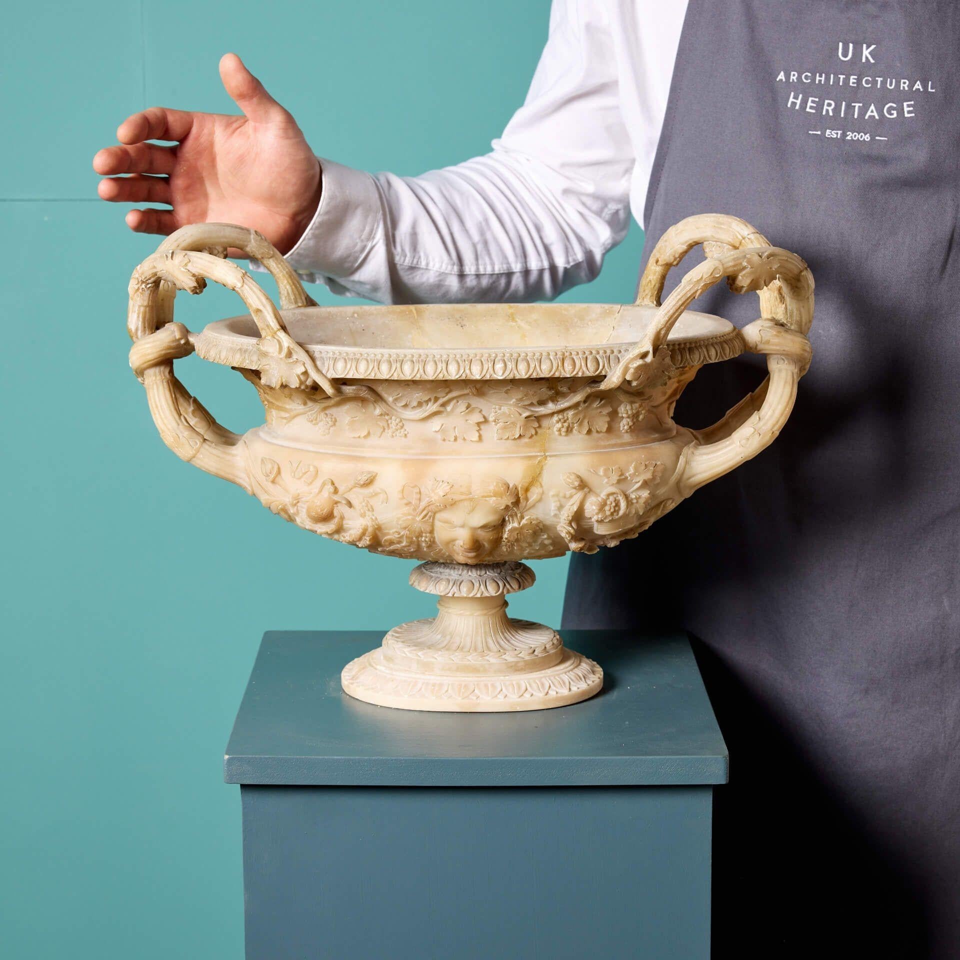 Un vase ou une urne en albâtre italien ancien, sculpté de façon exquise, vers 1860. Les détails de cette magnifique urne offrent un aperçu des styles de l'Italie du XIXe siècle. Le corps est finement sculpté avec des masques et des feuillages de