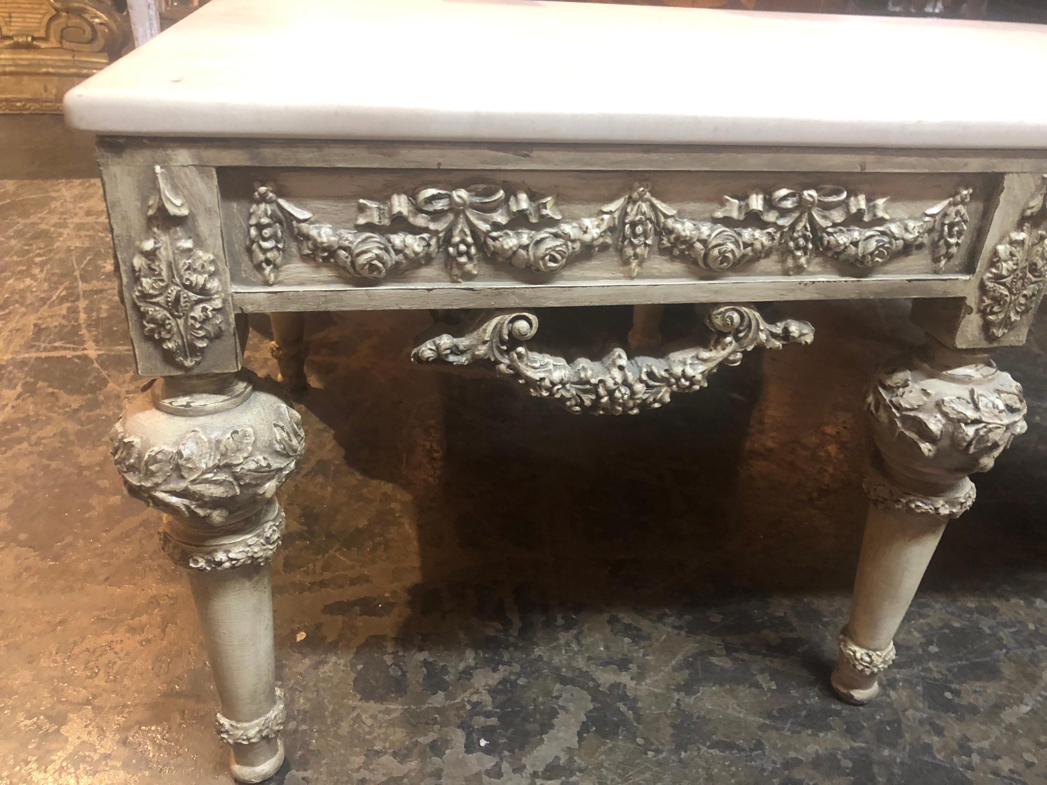 Beautifully carved Italian coffee table with a marble top. Carvings on this piece are very intricate. Impressive!