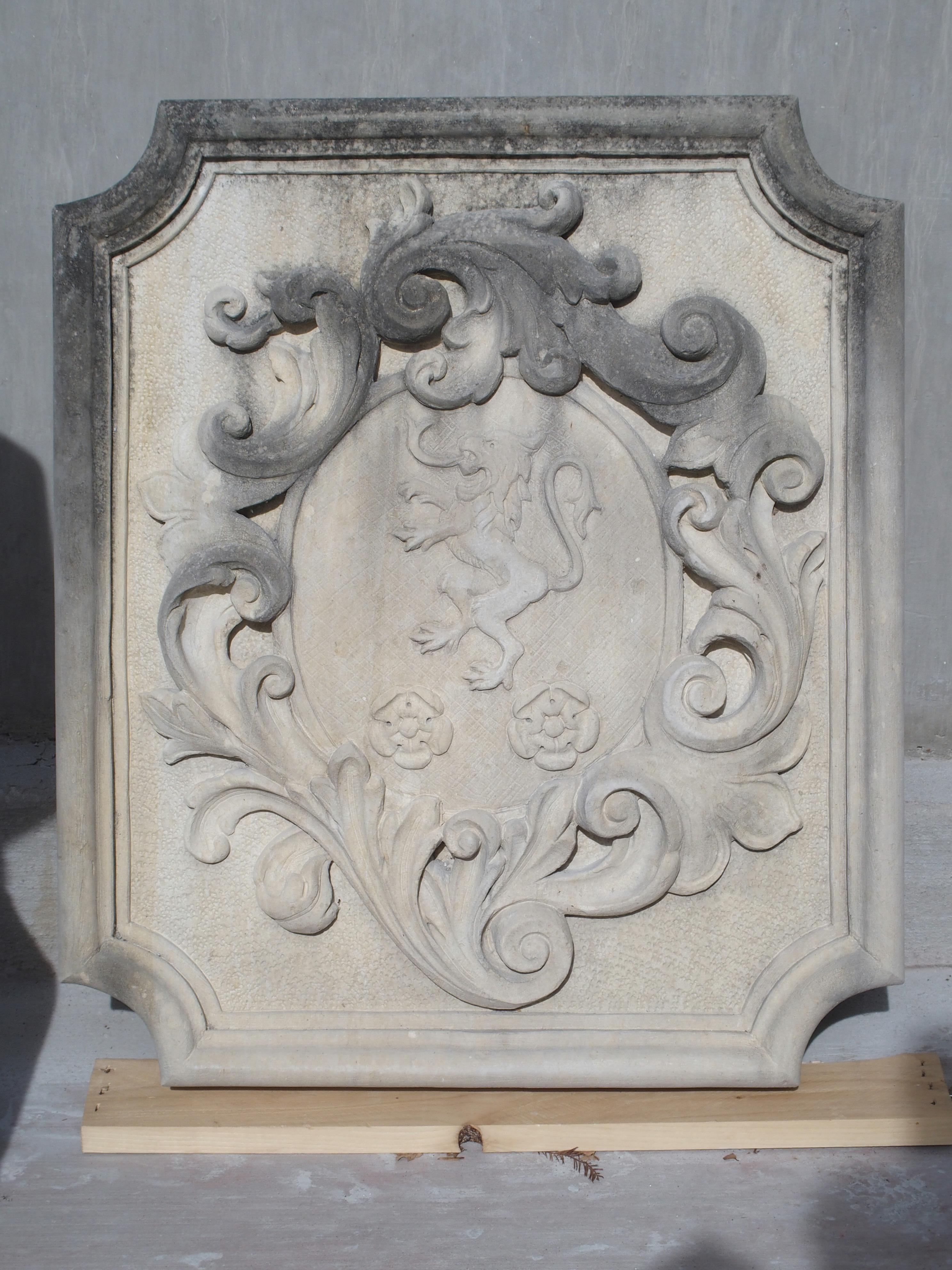 This masterfully hand carved coat of arms plaque is from Italy and made from natural Vicenza stone. It depicts a rampant lion facing left with two floral motifs beneath. Surrounding the center oval are large and flowing asymmetrical acanthus leaves