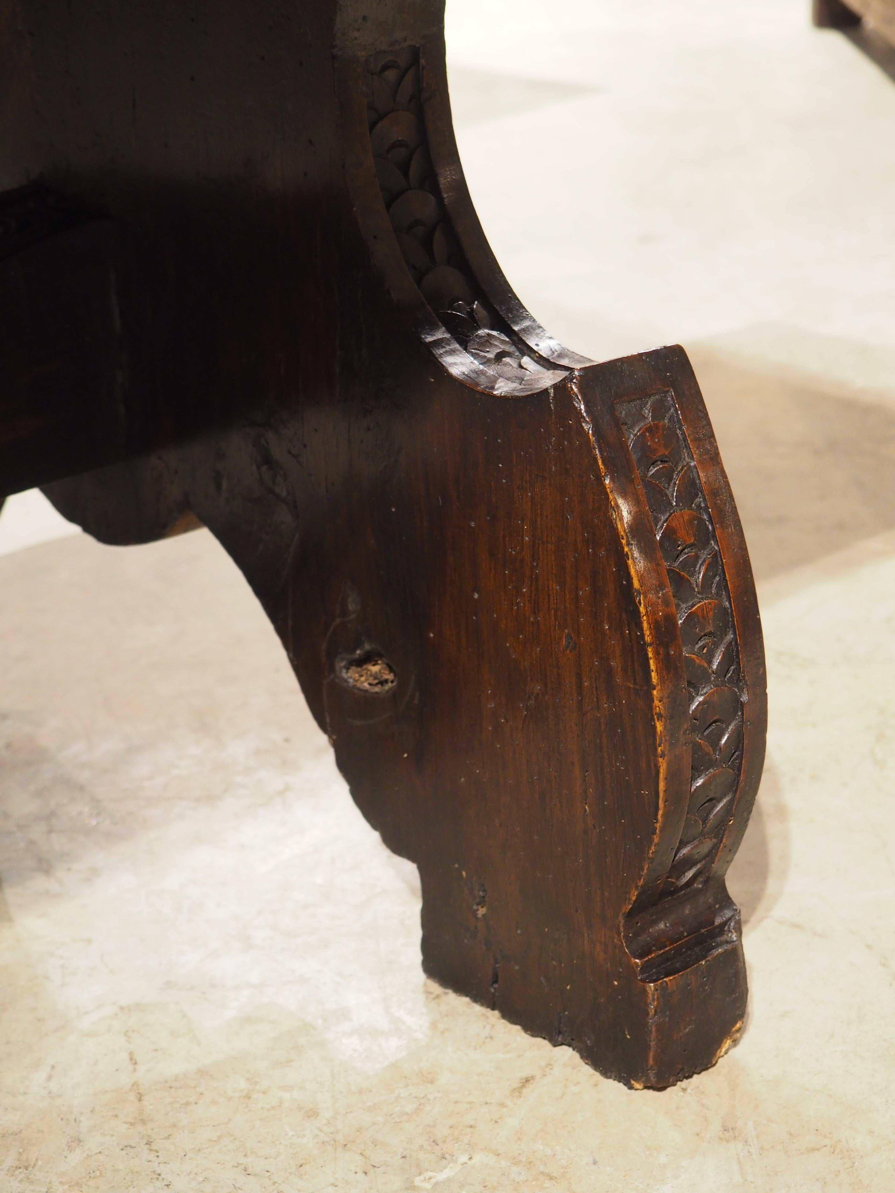 More information coming soon…

This Italian coffee table was hand-carved using walnut wood, some of which is centuries old. The thick top is supported by two shapely legs adorned with imbricated discs on the sides.