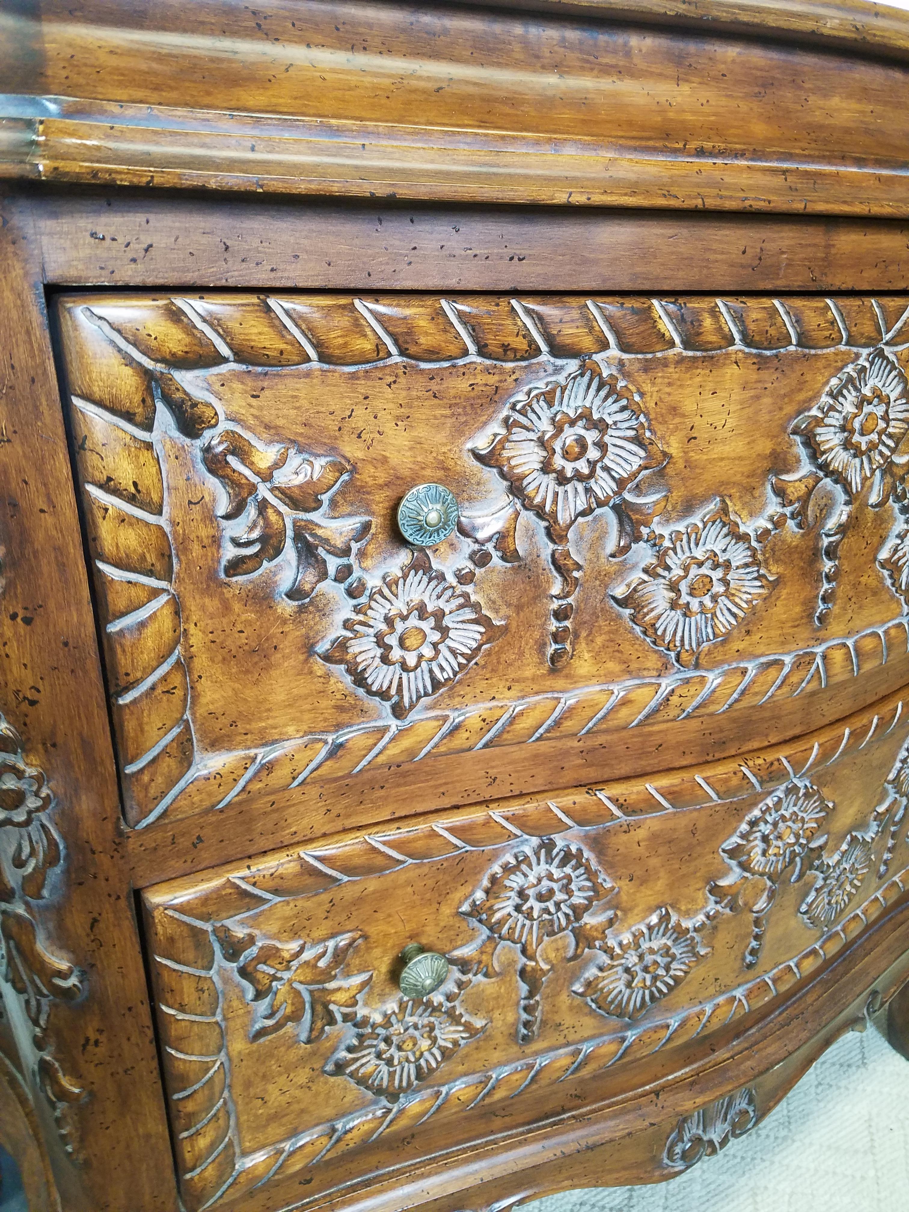 The chest with wonderful lines and beautifully carved decoration on the drawer fronts and sides on this semi bombe 2 drawer chest. Excellent quality and mint condition.
        