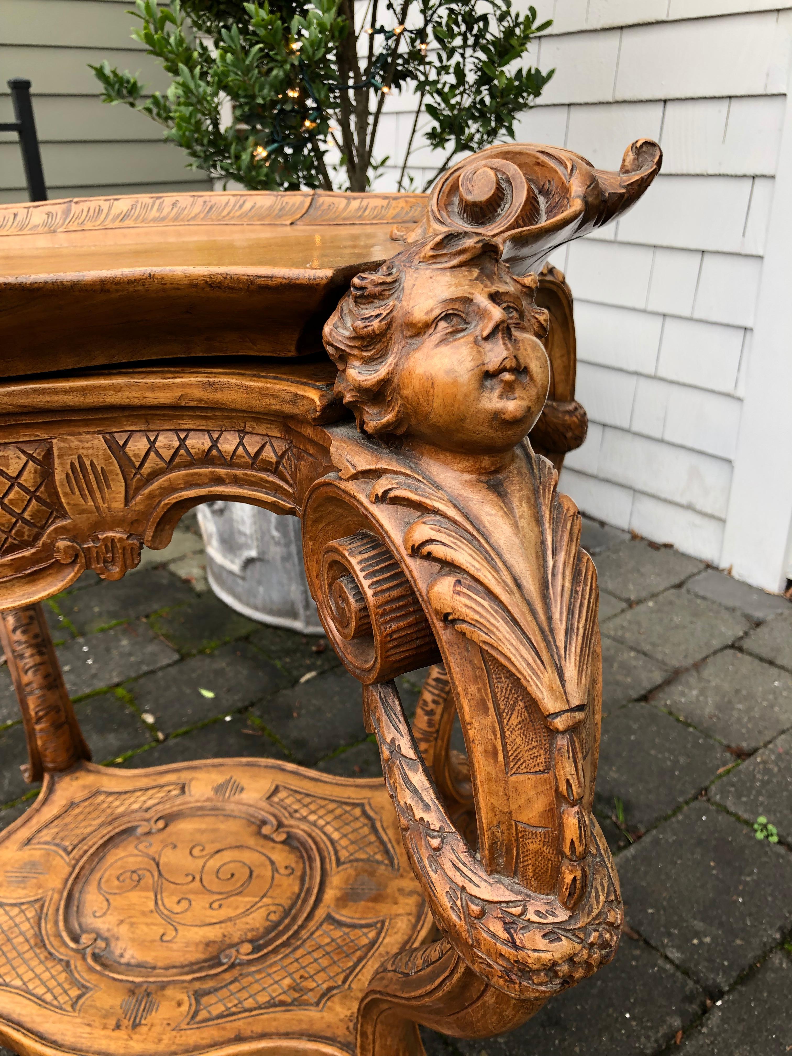 Beautiful Italian carved tray table with four cherubs and scroll work,

Early 20th century.