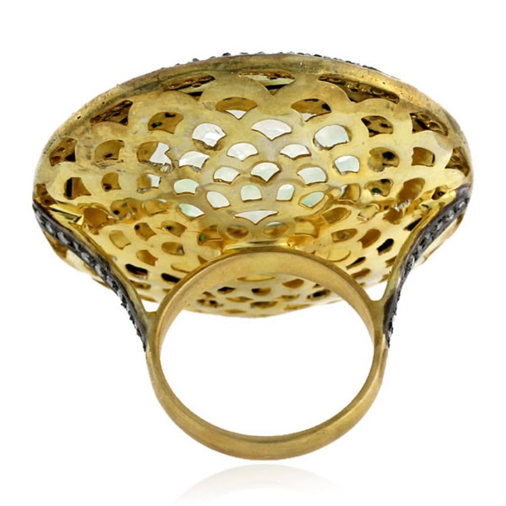 This stunning ring is truly a work of art, featuring a delicately carved jade center stone that is set in a striking 18k gold band. The filigree work surrounding the jade is nothing short of spectacular, with fine details that add a touch of