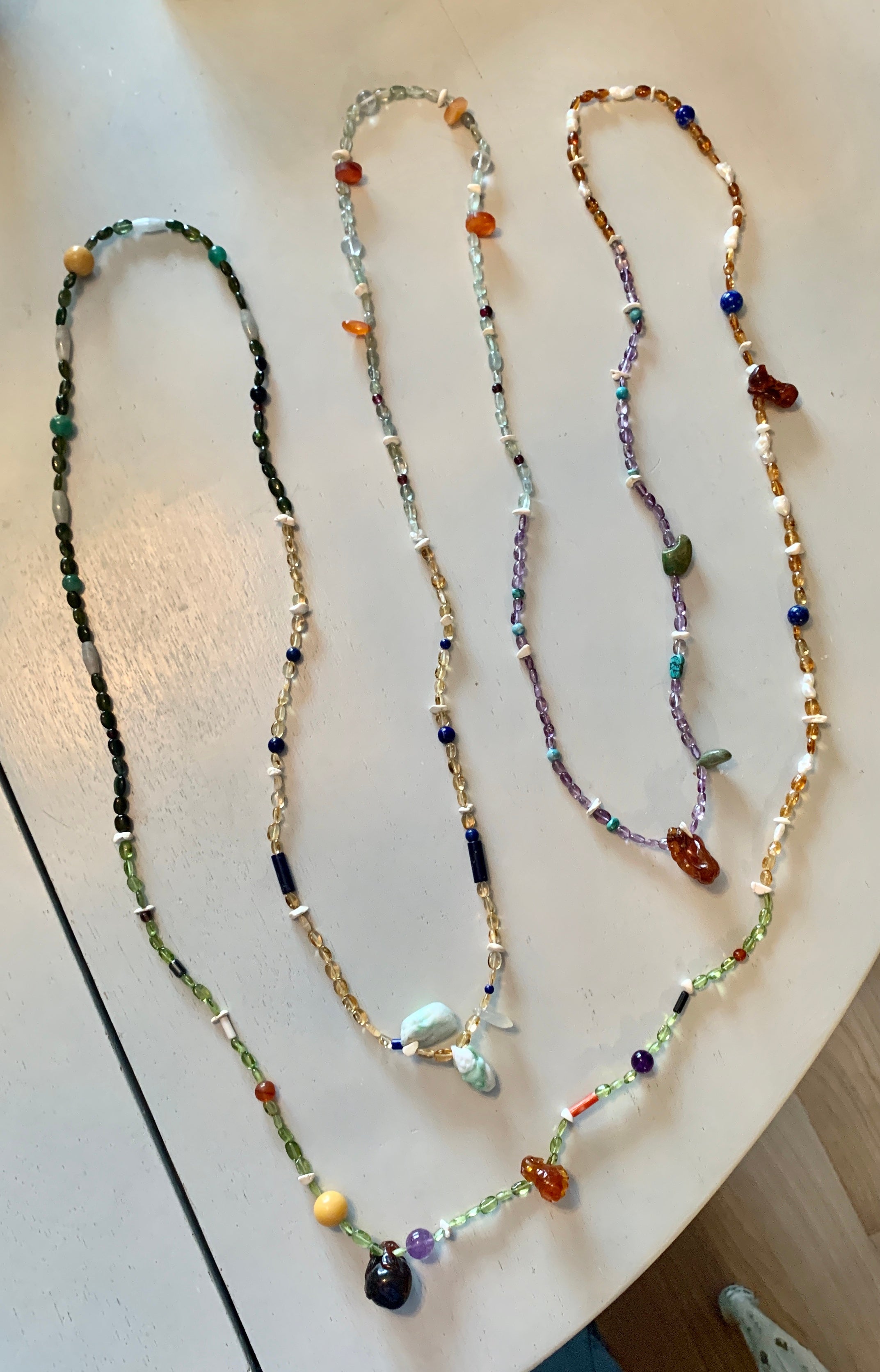 This is a stunning 10 Feet Long Multi Gem Necklace with carved charms in Jade and Amber in the form of a Rabbit, Monkey, Koi Fish, Fruit, Old Man and others with Citrine, Coral, Peridot, Topaz, Amethyst and other gemstones.  The necklace is 10 feet