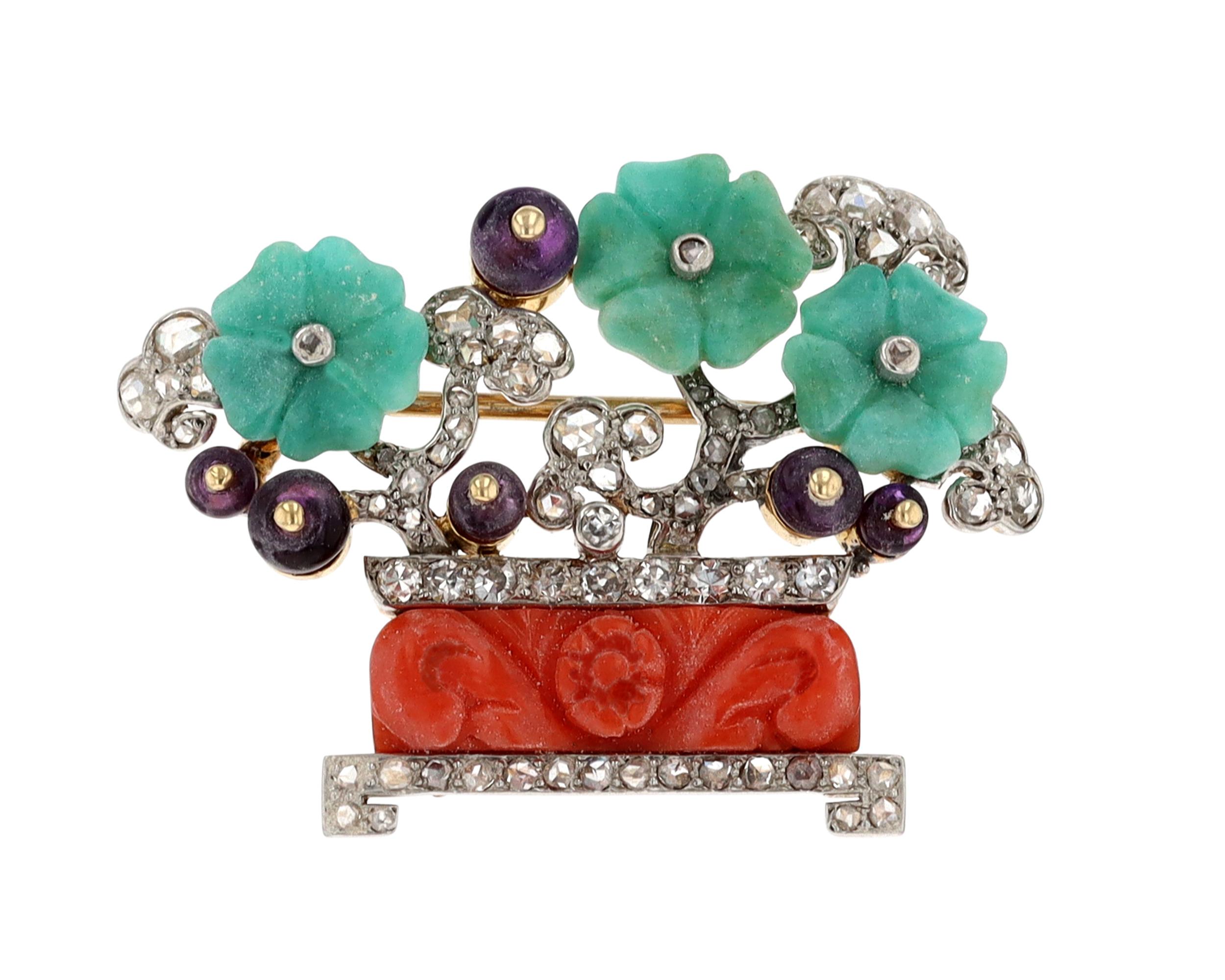 This charming Art Deco brooch crafted by the legendary Cartier takes the form of a vase holding a beautiful floral arrangement. Carved coral forms the base of the design, while carved jade and diamond accents create the blooms, lending brilliance to