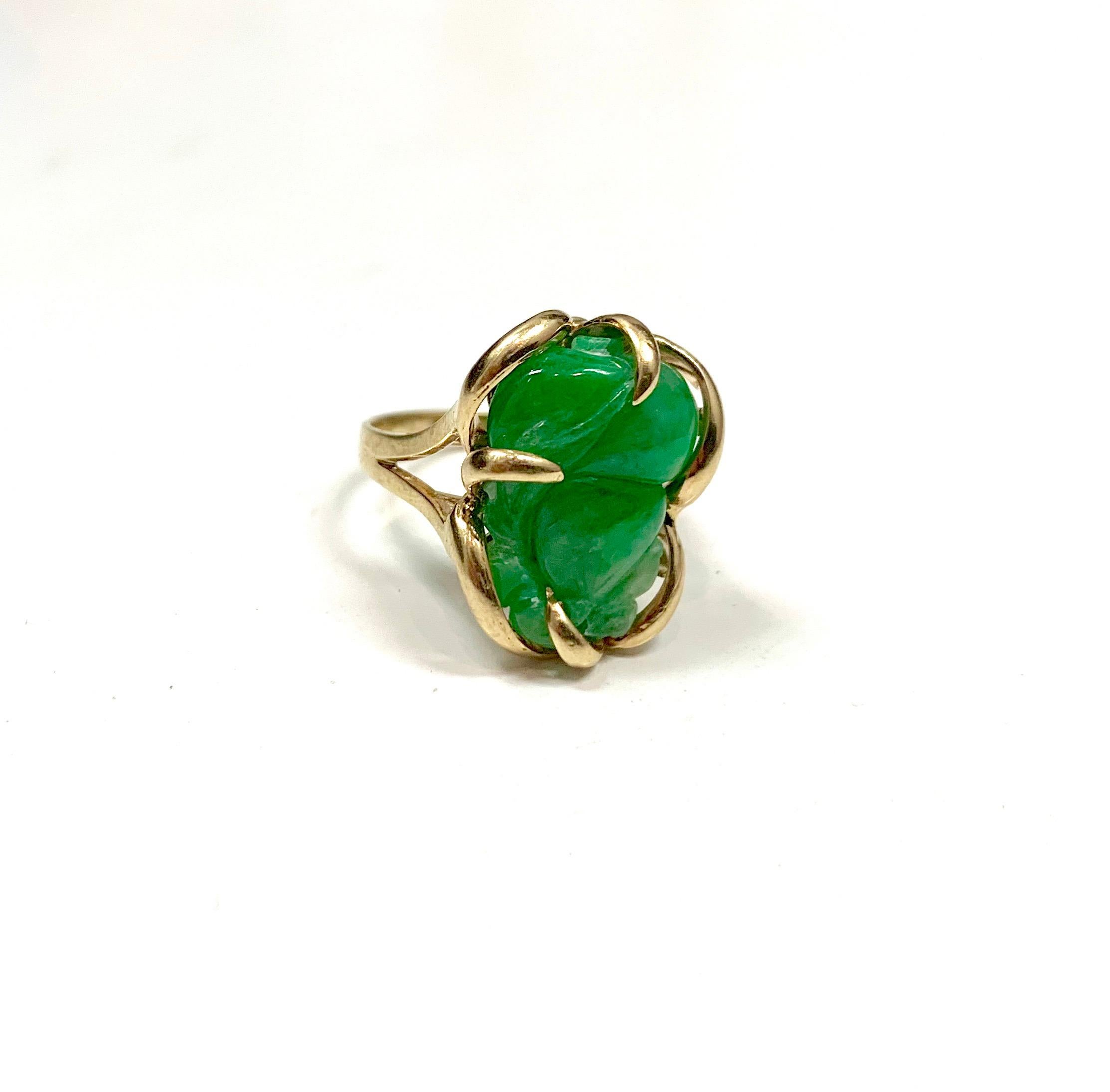 This jade ring has a center stone that measures approximately 22 x 10mm. The center stone has color zoning ranging from a rich green to a lighter green. The ring is cast from 14k yellow gold and has both 585 and 14k hallmarks inside the ring. The
