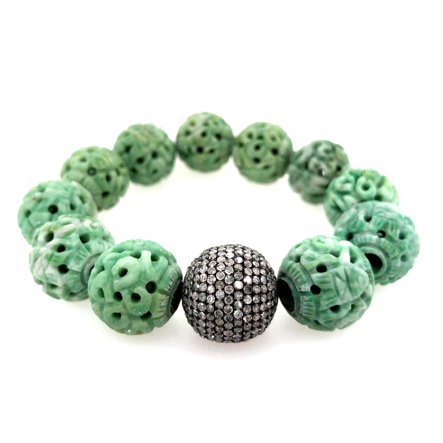 Great to stack this Carved Jade and Pave Diamond Stretchable Bracelet in Silver is lovely and such a eye catching piece. Diamond Pave ball bead and Jade Beads are 16mm big


Silver:15.59gms
Diamond:8.67cts
Jade:224cts
