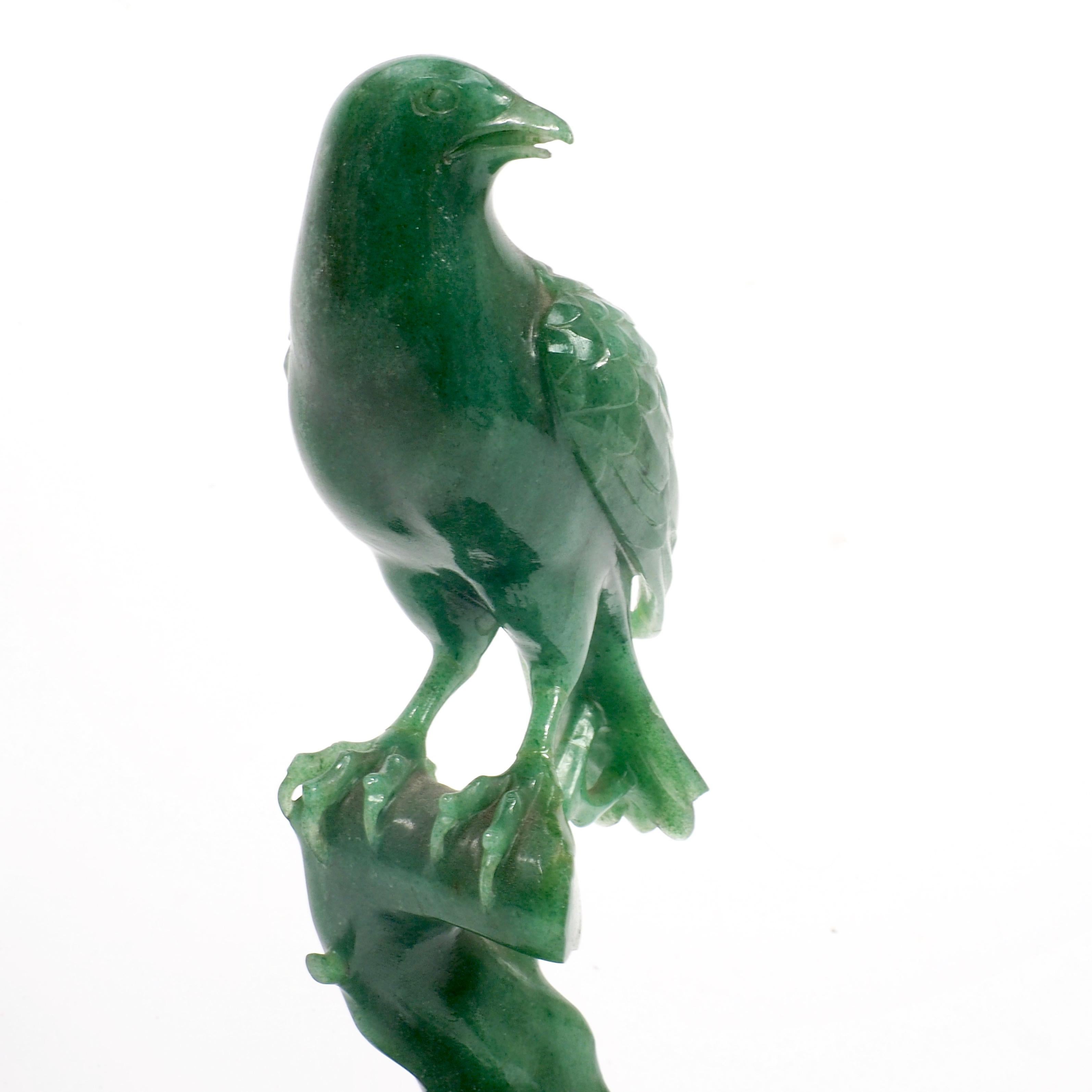 Exquisitely carved jade songbird of the late Qing dynasty, circa 1900. Made of vivid green Feicui or Kingfisher Jade which became a favourite of the Qing dynasty. The base of carved fruitwood has been repaired.