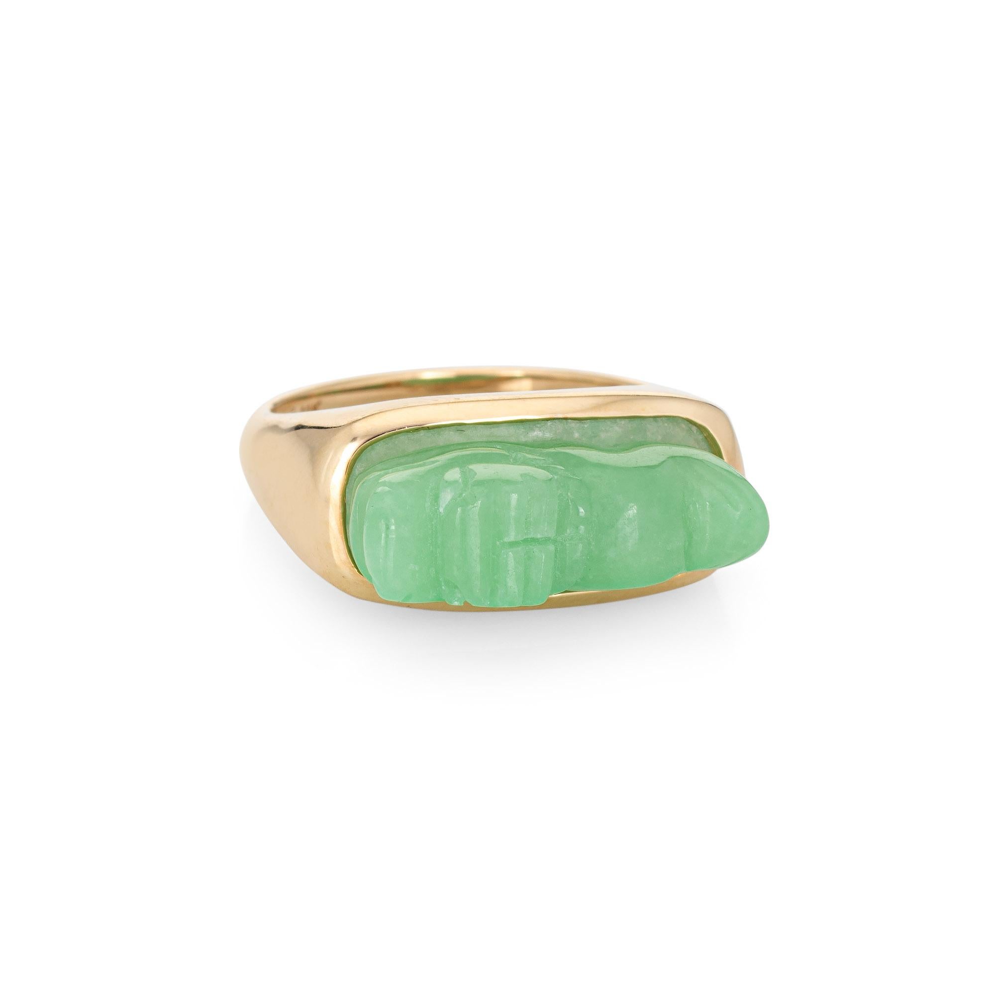 Stylish vintage carved jade dragon ring crafted in 14 karat yellow gold. 

Carved jade measures 24mm x 7mm. The jade is in very good condition and free of cracks or chips. 

Jade is carved in the form of a dragon, a symbol of strength and fire. The