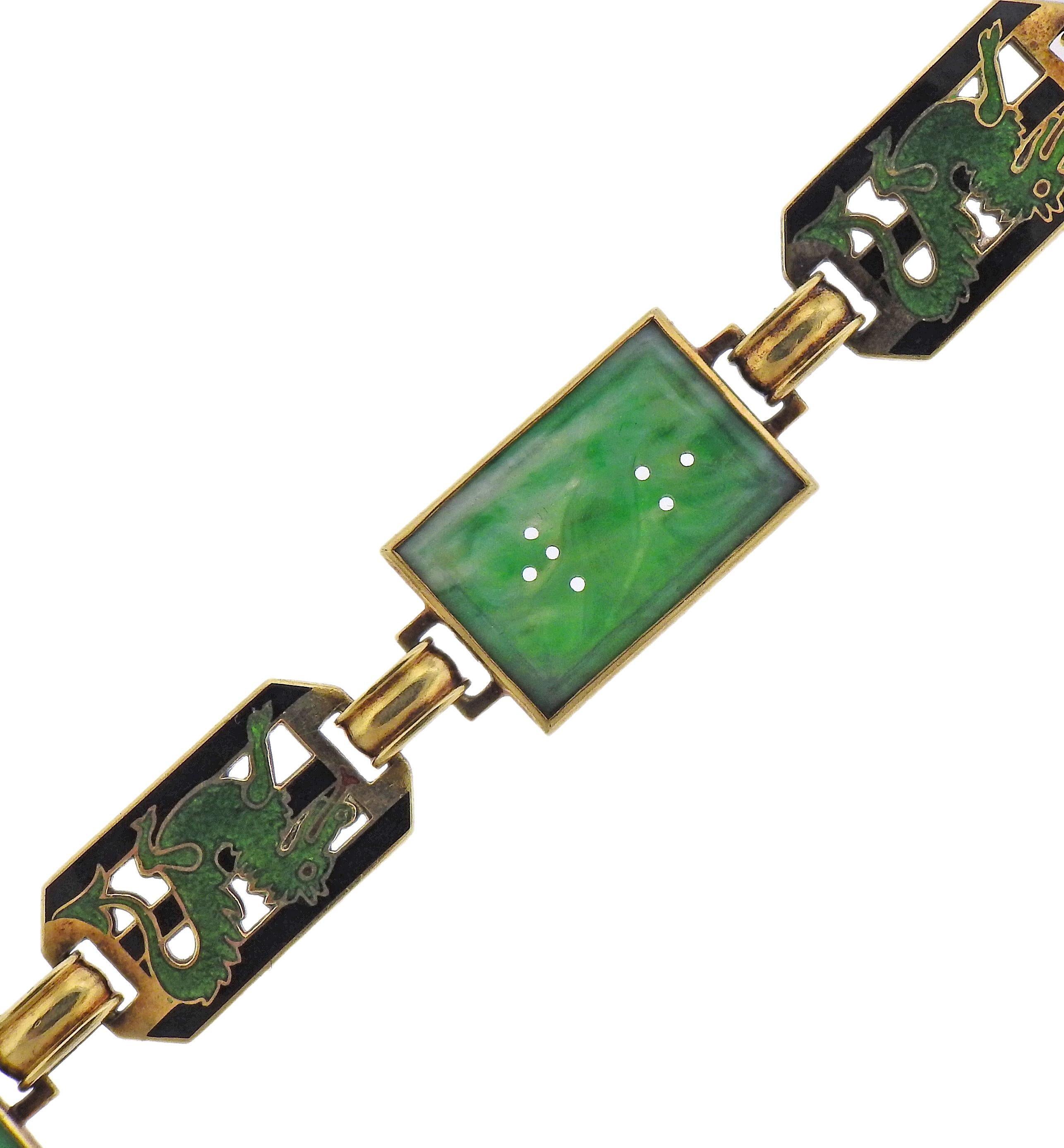 14k gold bracelet, featuring three carved jade elements and enamel dragon links. Bracelet is 7.5