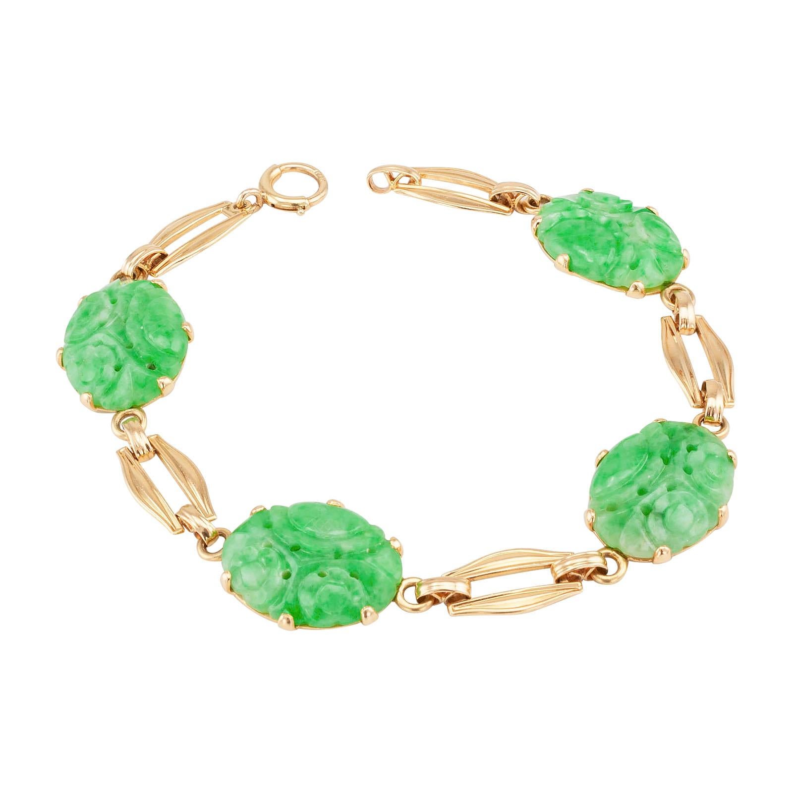 Carved jadeite and gold link bracelet by Church & Co.  circa 1950.

DETAILS:
GEMSTONES:  four oval light green carved jadeites.

METAL:  14-karat yellow gold.

HALLMARKS:  maker’s mark for Church & Co.

MEASUREMENTS:  approximately 7 ½” (19.0 cm)