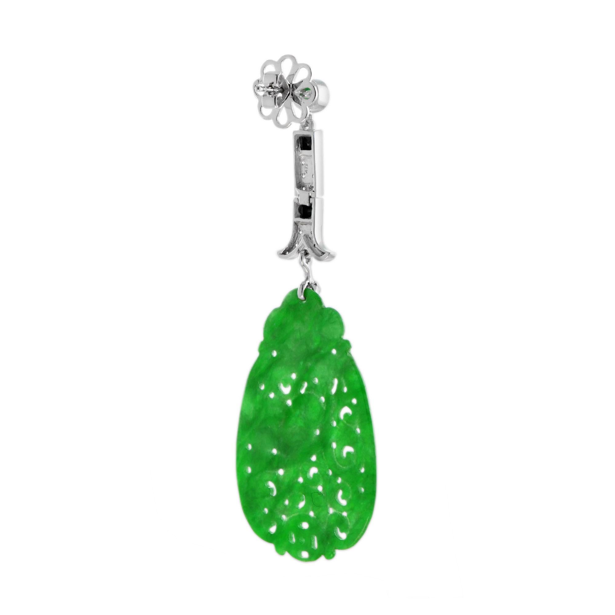 This extraordinary dangle earrings are all you need! Made in 14k white gold, the top link of these earrings is cabochon emeralds, onyx, and small white diamonds. It is greatly possessed by beautifully carved jade stone. The fusion of the white gold