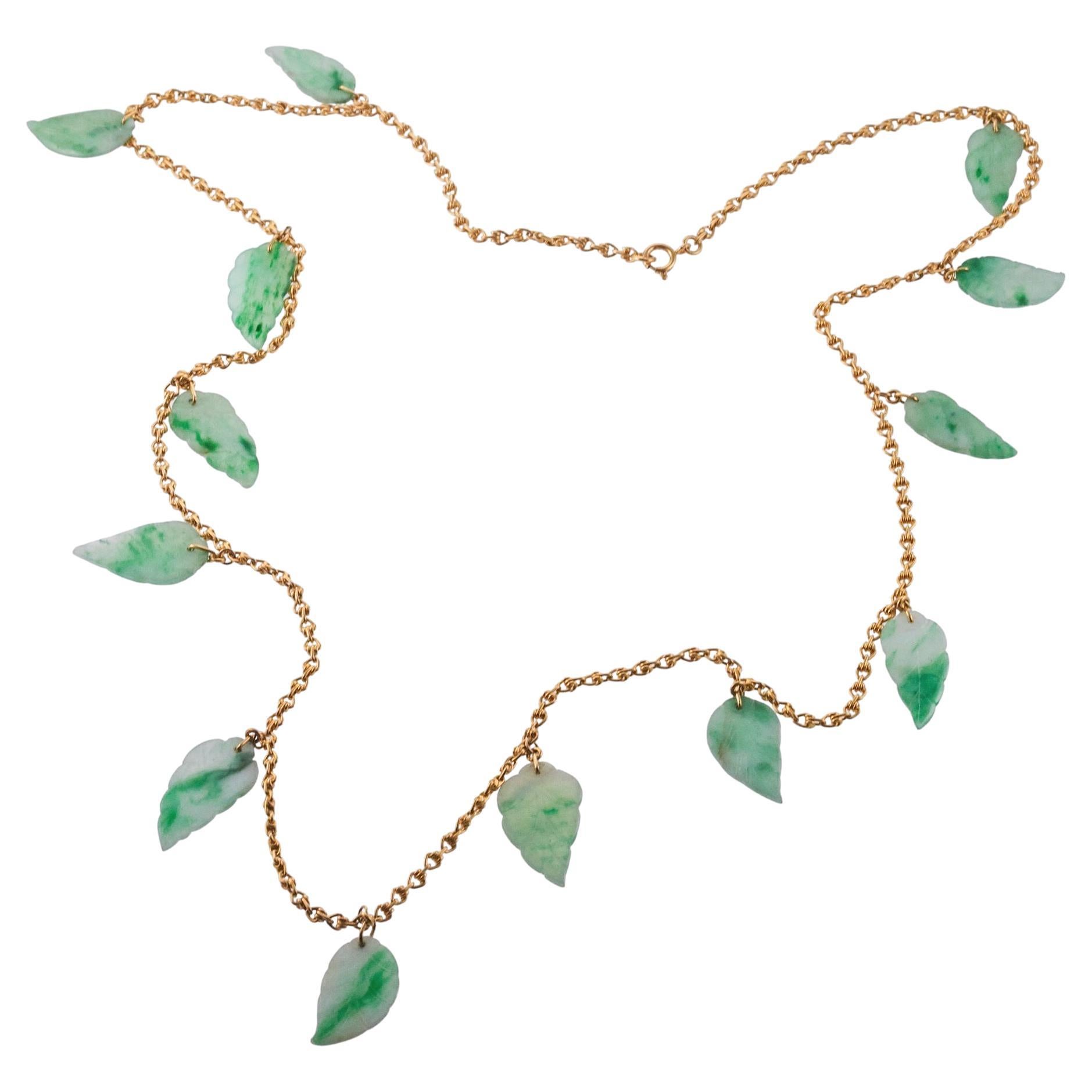 Long 18k gold chain necklace, with 13 carved leaves jade pendants, each measuring approx. 1
