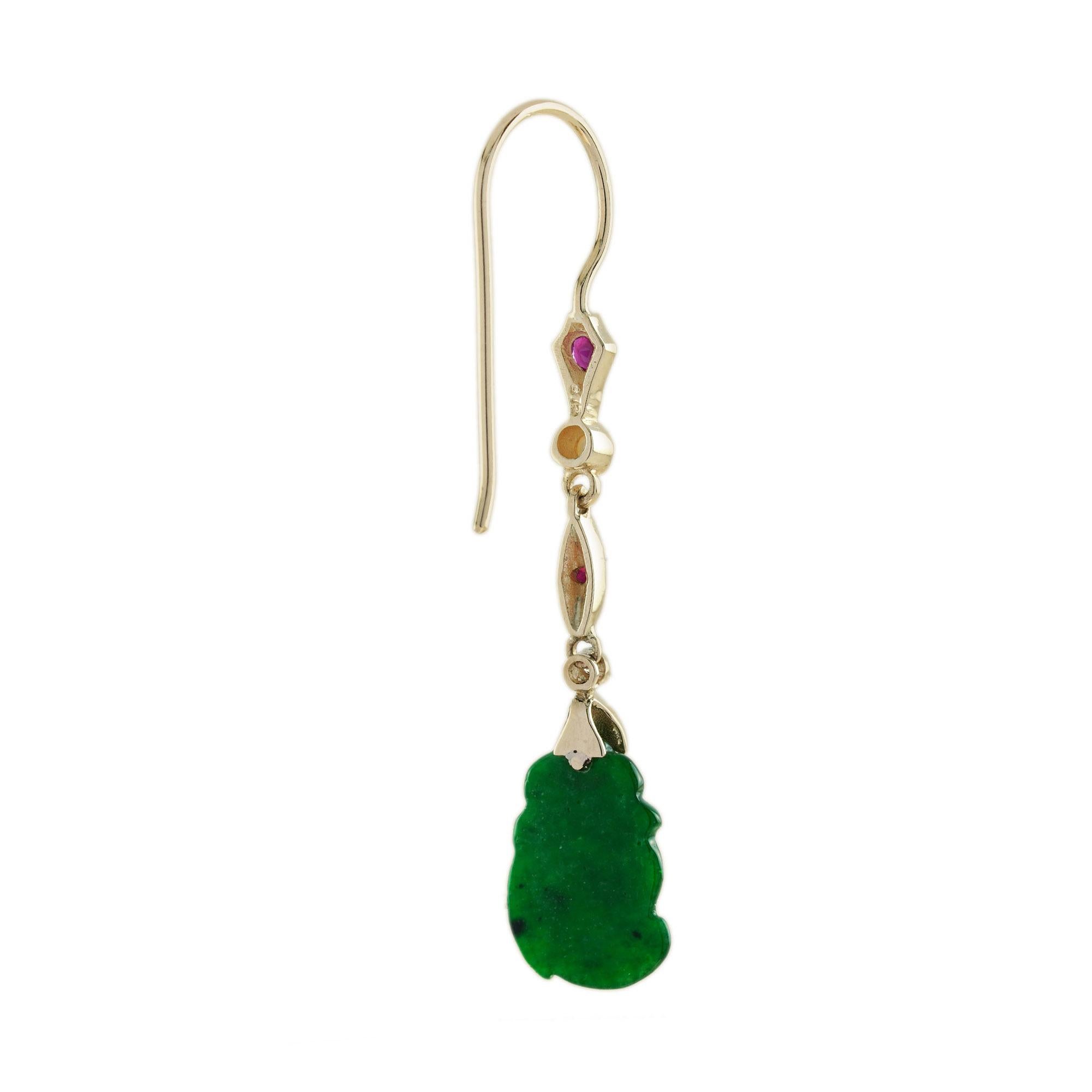 The natural jade in these lovely earrings has some very special shape. Both pieces have a strong green color and well carvings. The jade is suspended in a 9k yellow gold setting with ruby, pearl and diamond link on the top. The earrings transfer