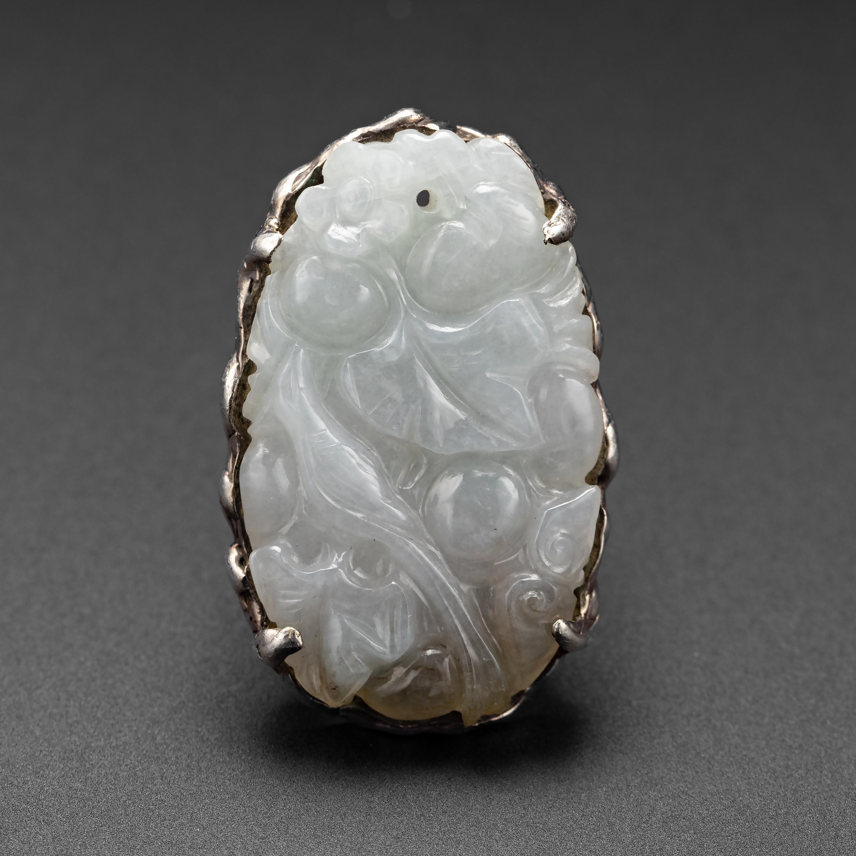 This entirely handmade modernist ring dates from the 1960s and was created to showcase a stunning, translucent, and nearly colorless jade carving. Measuring 40.66mm x 24.71mm, the carving is quite impressive. It was skillfully carved to depict a