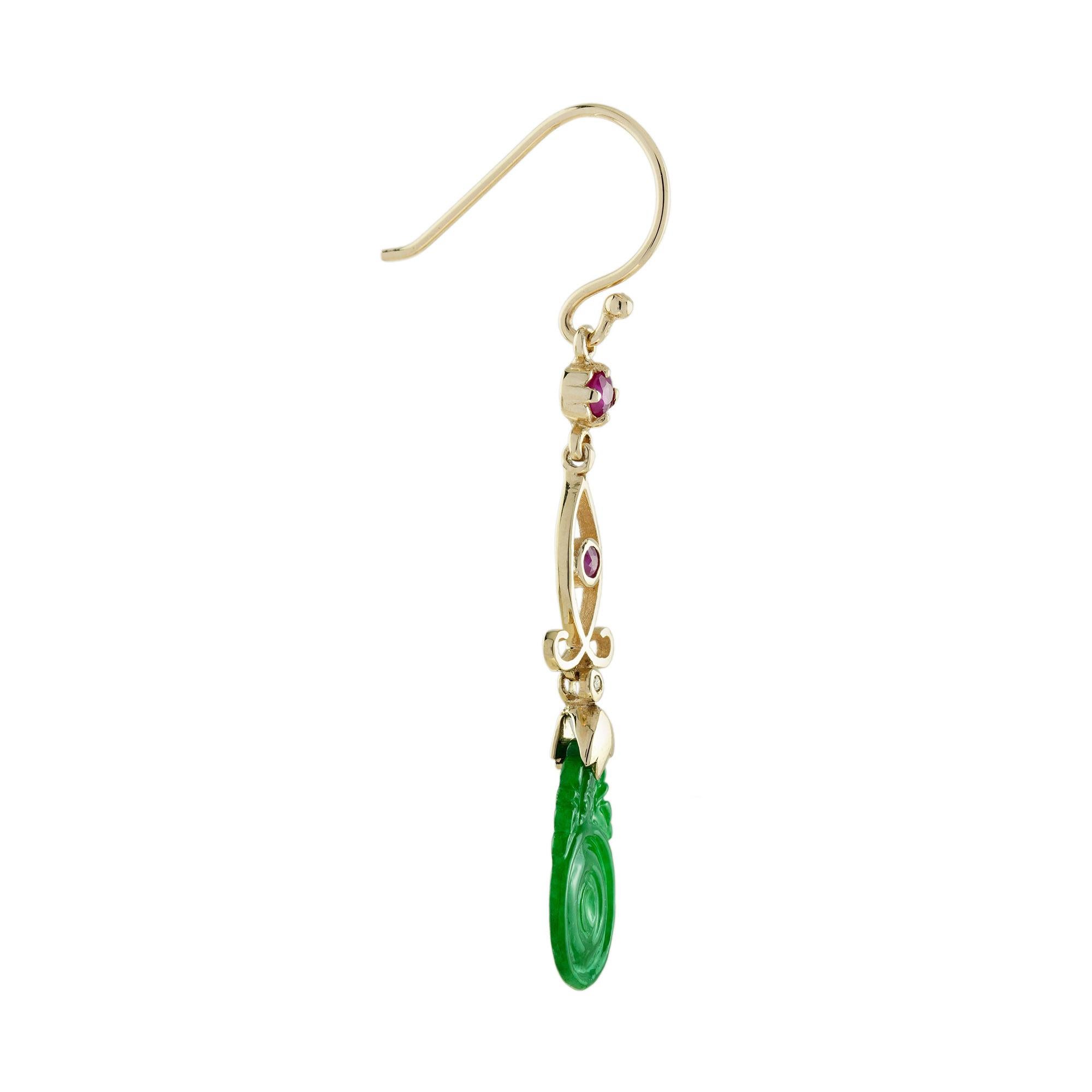 The natural jade in these lovely earrings has some very special shape. Both pieces have a strong green color and well carvings. The jade is suspended in a 9k yellow gold setting with ruby and diamond link on the top. The earrings transfer their good