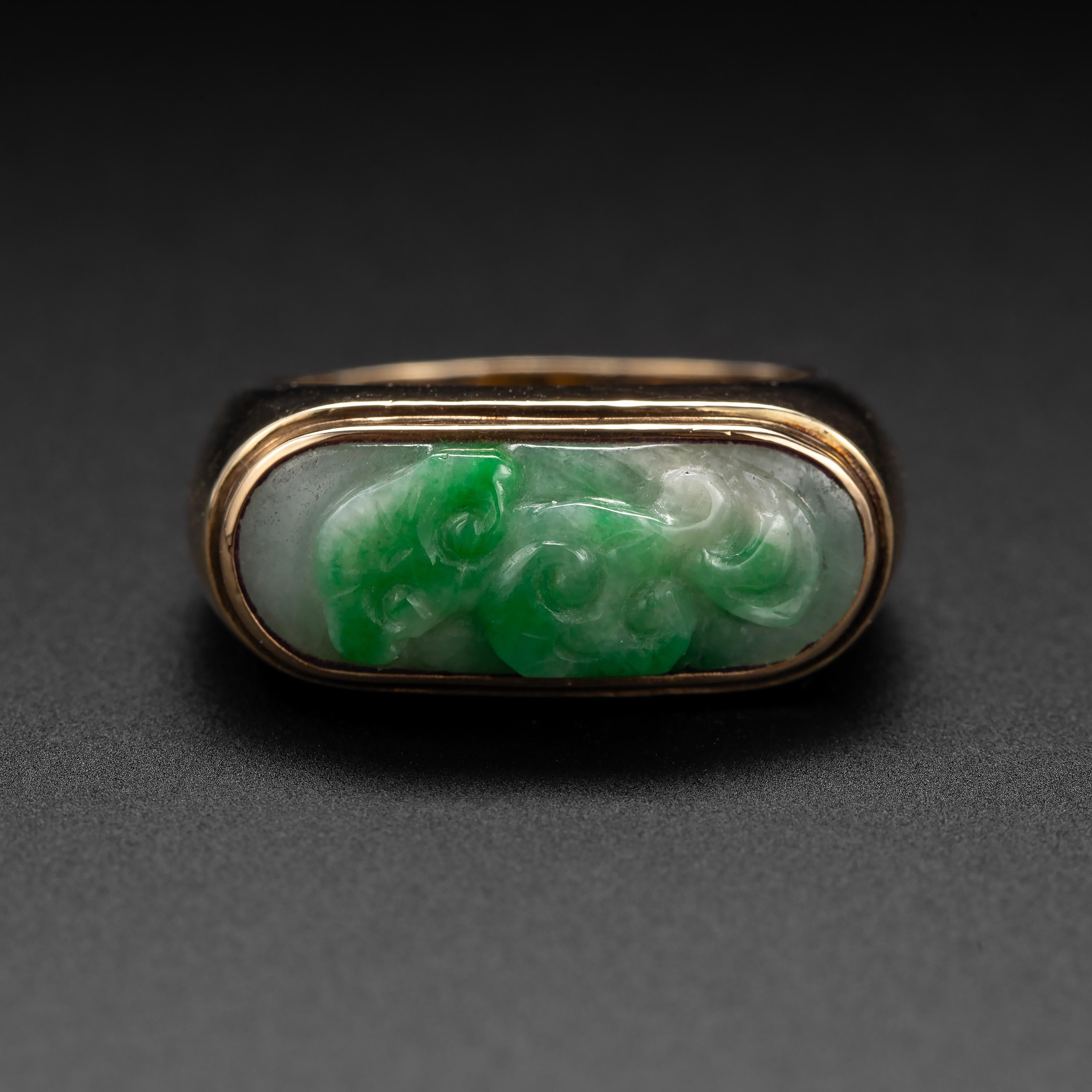 You've seen a jade saddle ring: a simple band of gold or silver that wraps around your finger with a bar of jade running West to East across the face. It's the classic jade ring. And this ring is a twist on that classic form: it's a carved jade