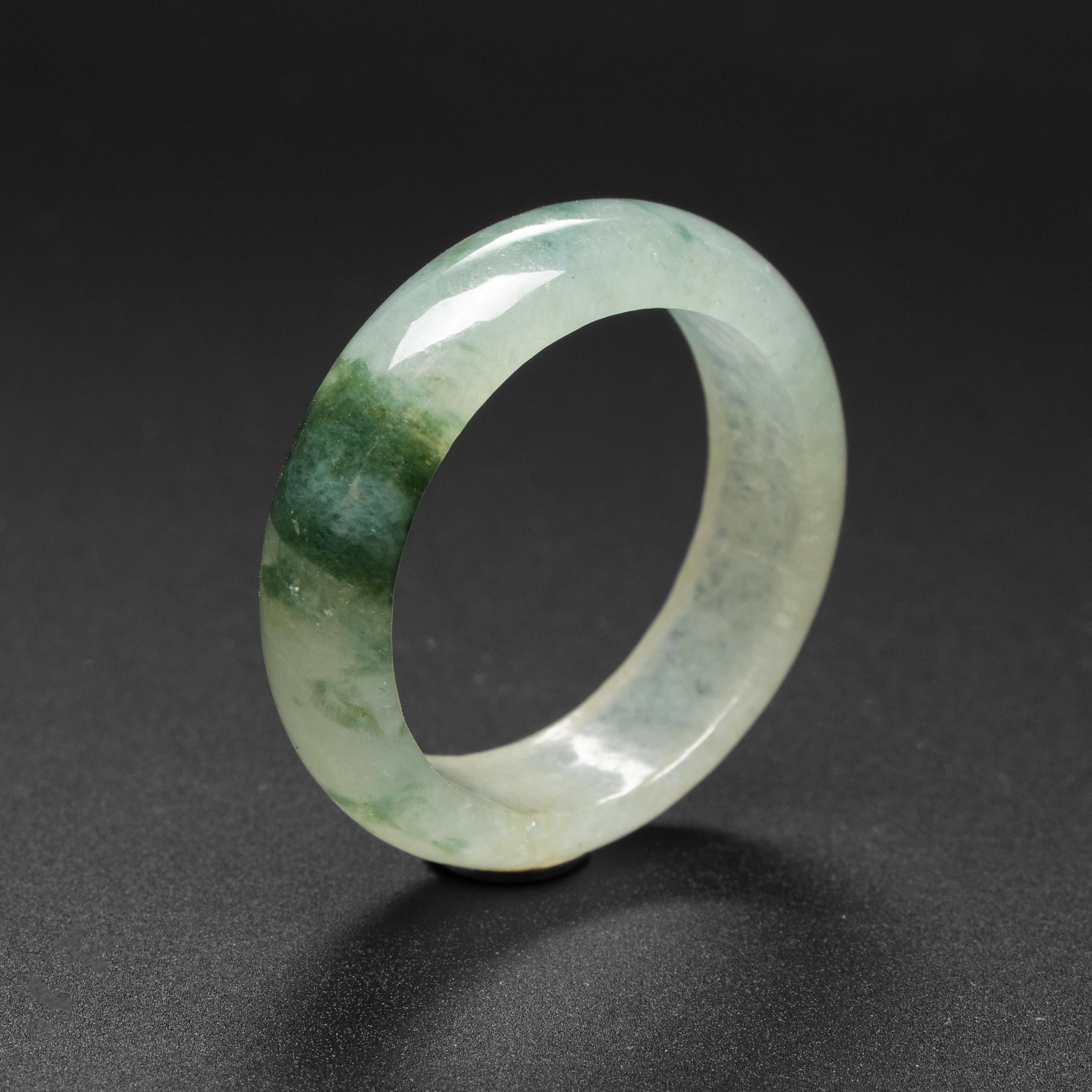 This hand-carved jadeite jade ring is highly translucent and displays a lovely, fibrous grain that makes the stone look like ice; hence this kind of jade is commonly referred to as 