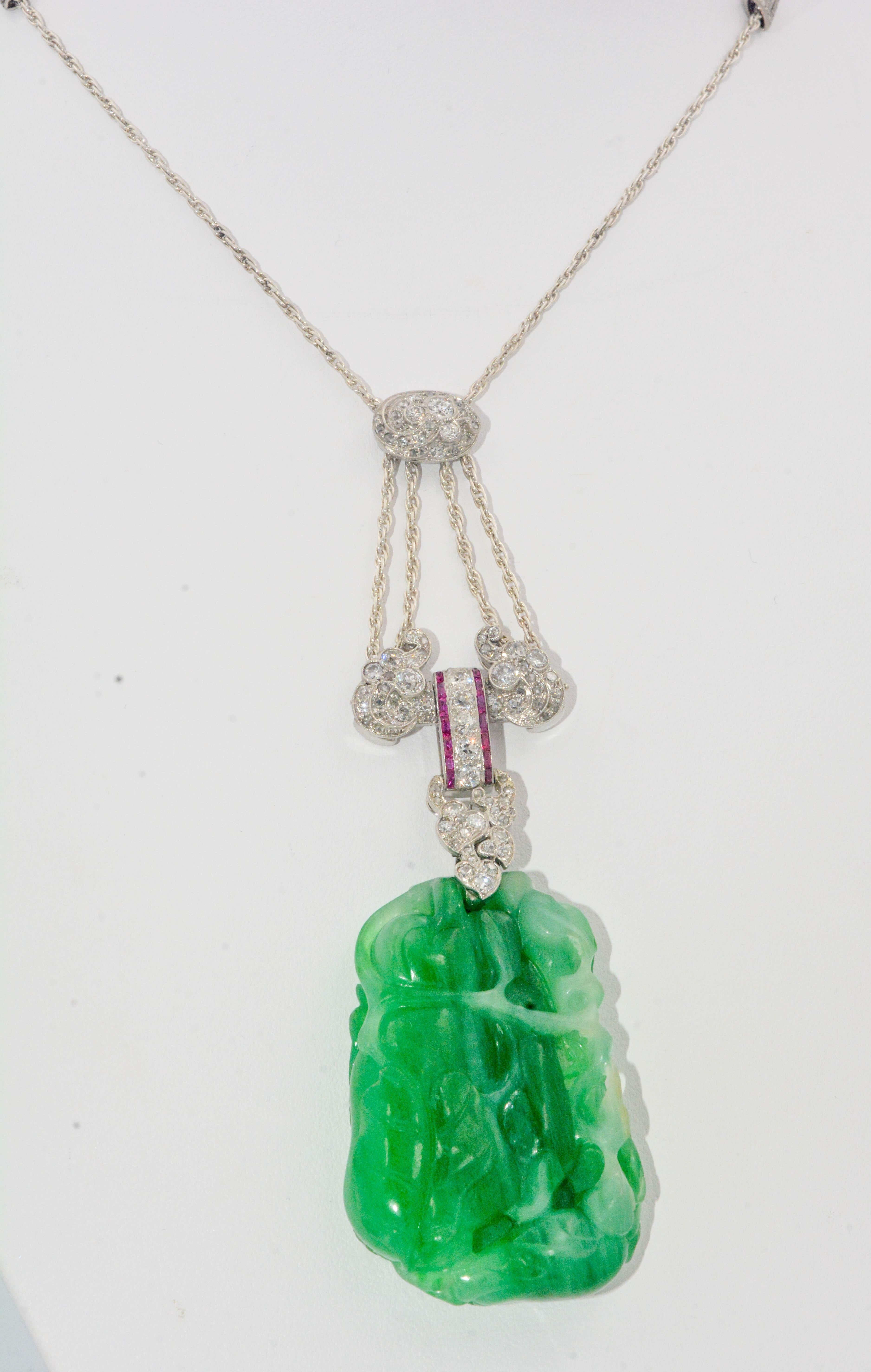 Presenting  this divine Art Deco Circa 1930 platinum necklace with a carved jadeite pendant. High quality jade is carved with banana leaves. Bagguette rubies 0.24 ctw are surrounded by Old European and Rose cut diamonds 1.51 ctw (G-H color, SI