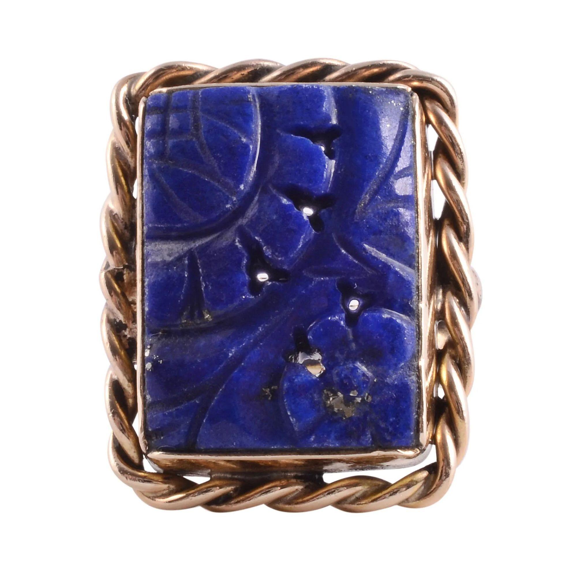 Vintage carved lapis 14KY ring, circa 1955. This 14 karat yellow gold ring features a rectangular carved lapis set in a twisted wire frame. This vintage lapis ring is a size 6. [KIMH 1881 P]

Dimensions
.95″H x .87″W x .25″D