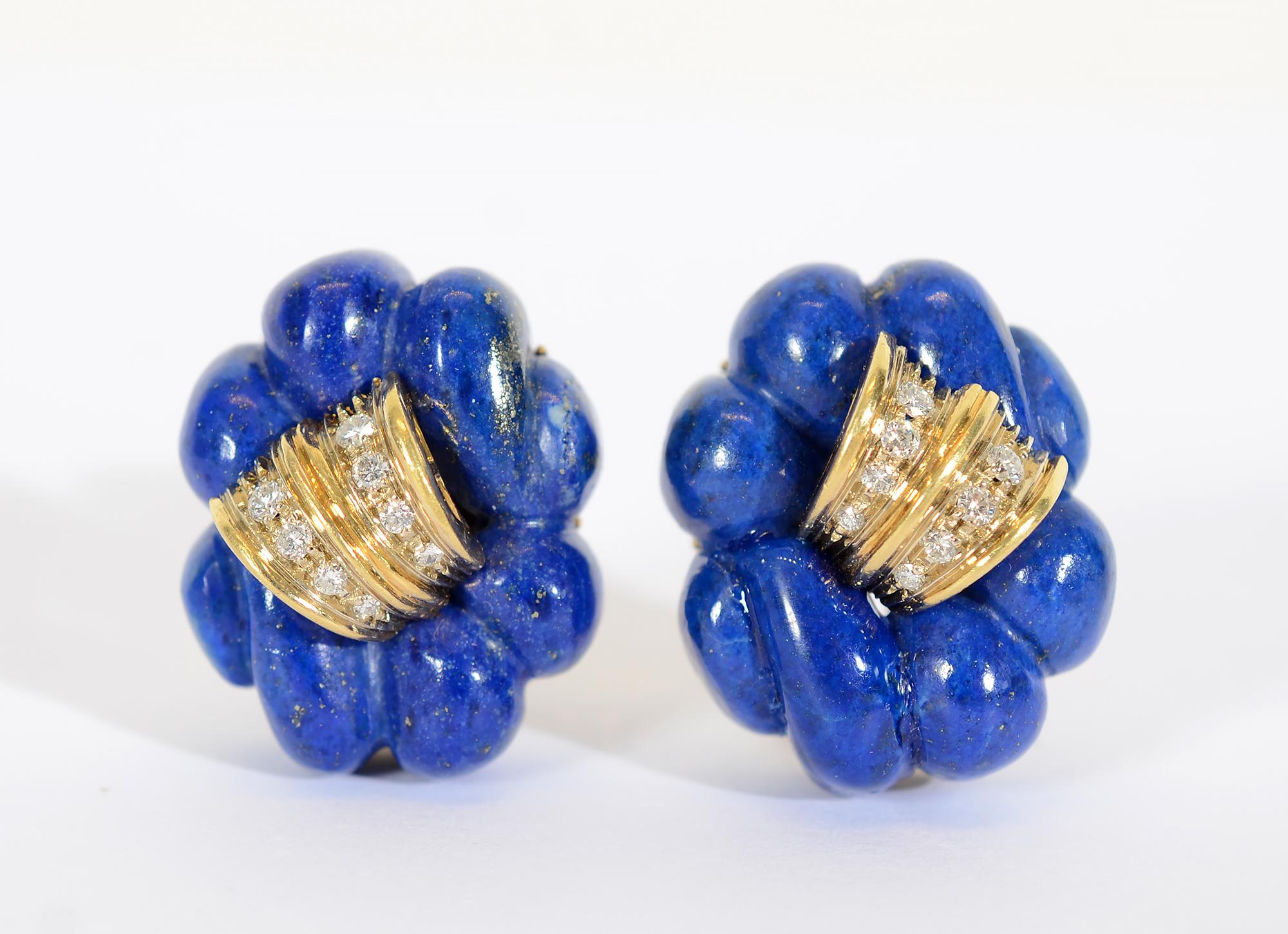 These fabulously sculptural carved lapis lazuli earrings are centered with gold and diamonds. They measure 1 1/16
