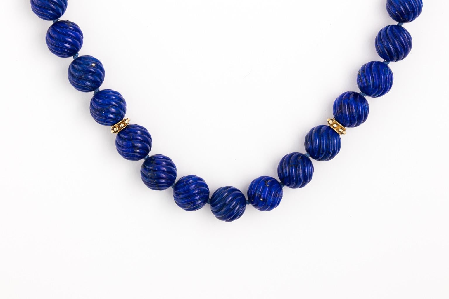 Rich Royal blue Lapis beads carved in swirly pattern. Each bead is 12 mm and 19 inches long includes the gold chain and bar, but not the toggle ring. The entire necklace is 85 grams. There are a lot of gold on this necklace. The toggle bar and ring