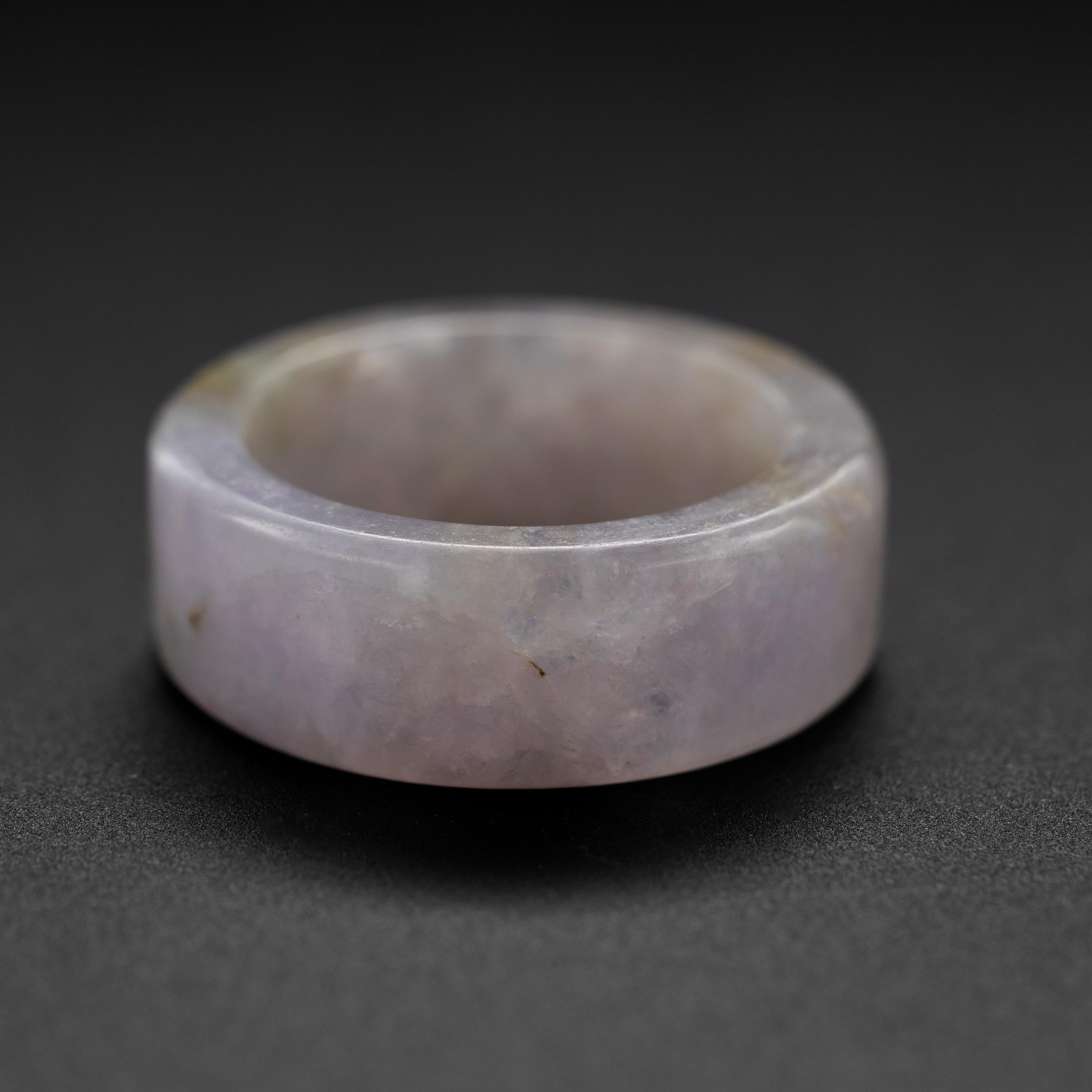 The straight lines and uniform spherical shape make this hand-carved lavender jade ring unique. The vast majority of rings carved from a single piece of jade are contoured more like the profile of a wedding band: convex, or else they are carved in
