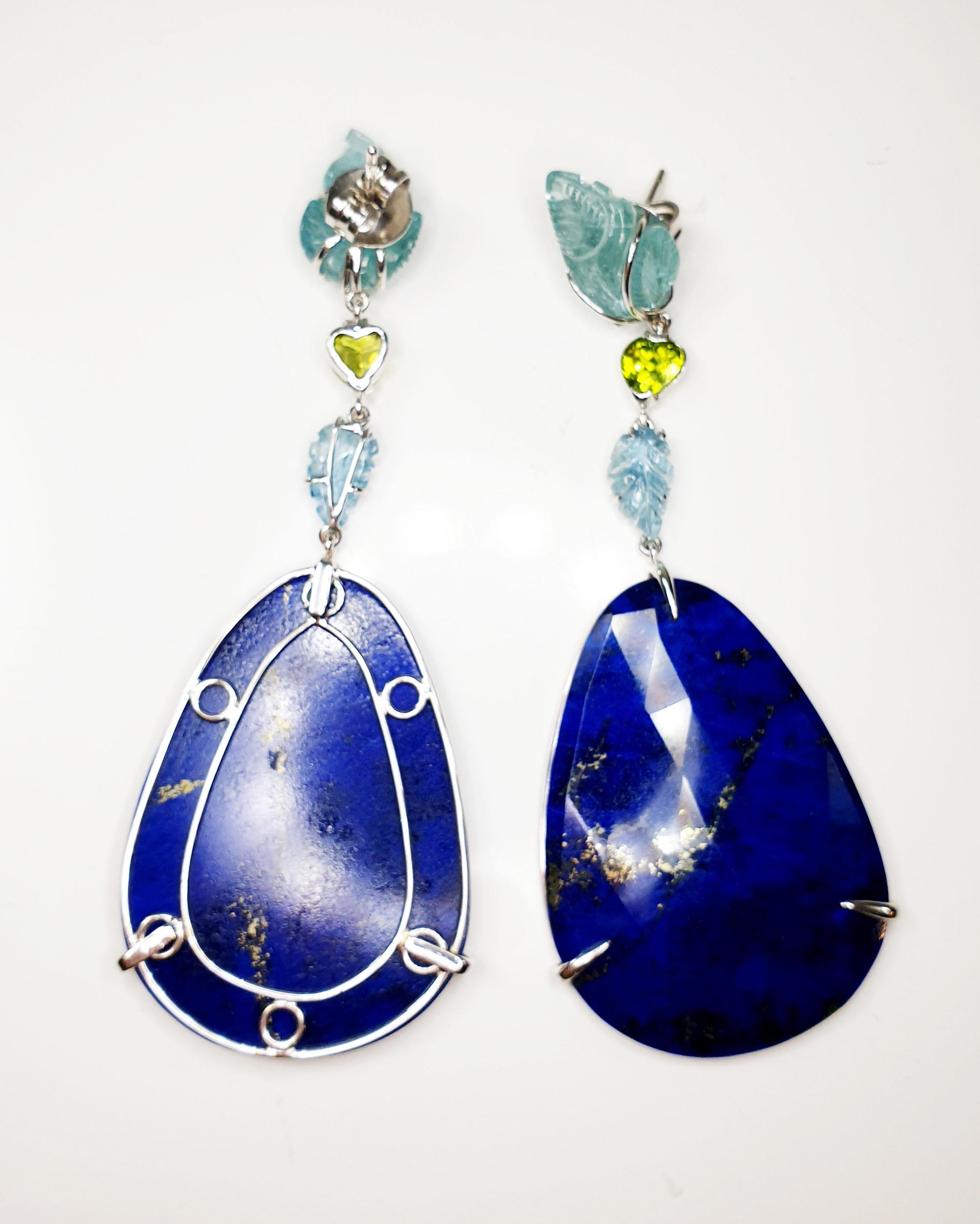 Carved leafs aquamarines peridot in 18k gold earrings with lapis lazuli drops
Irama Pradera is a Young designer from Spain that searches always for the best gems and combines classic with contemporary mounting and styles. 
This Carved Aquamarines