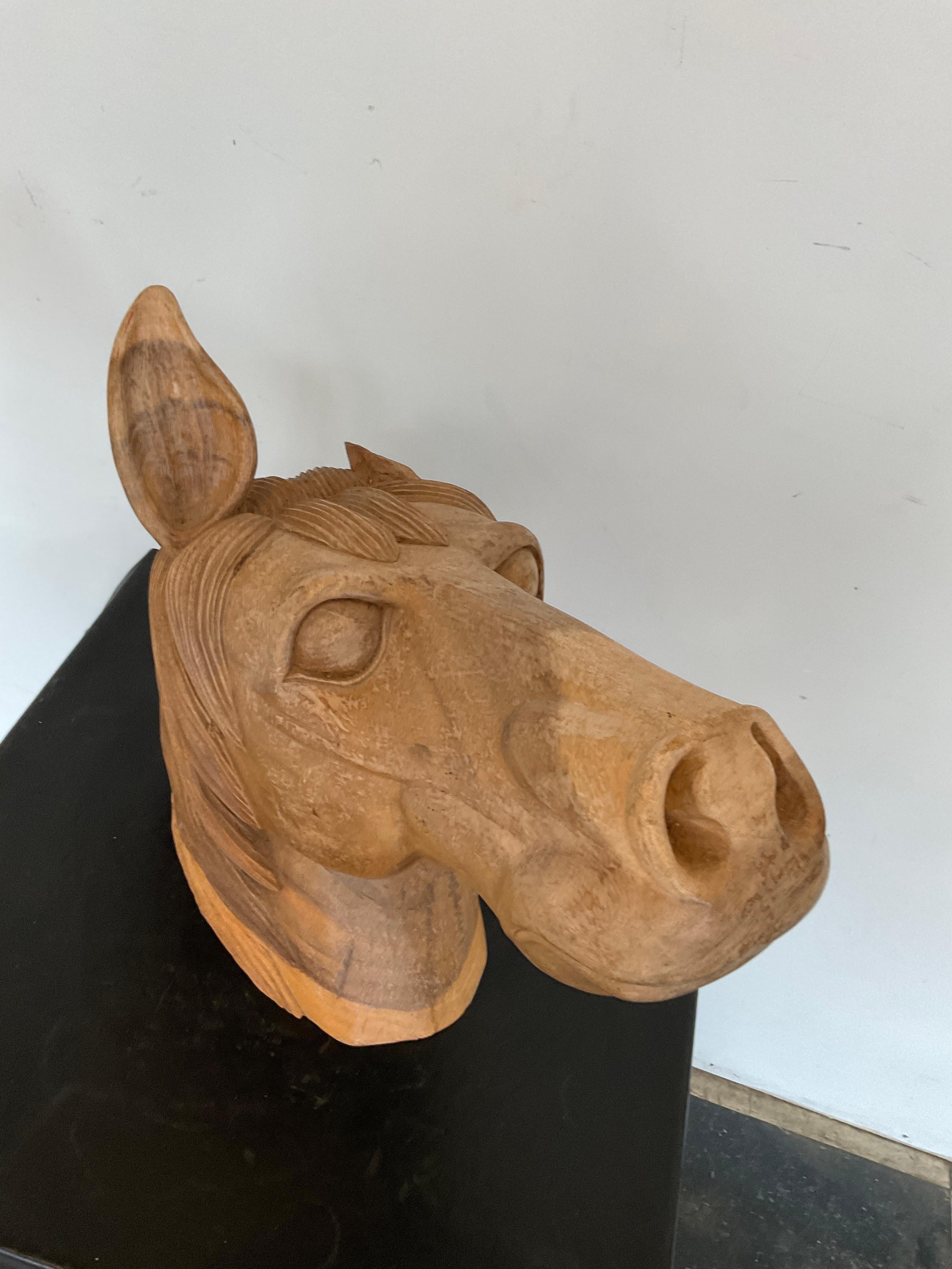 1960s Hand carved horse head. Carved from one piece of solid wood. One ear is missing.