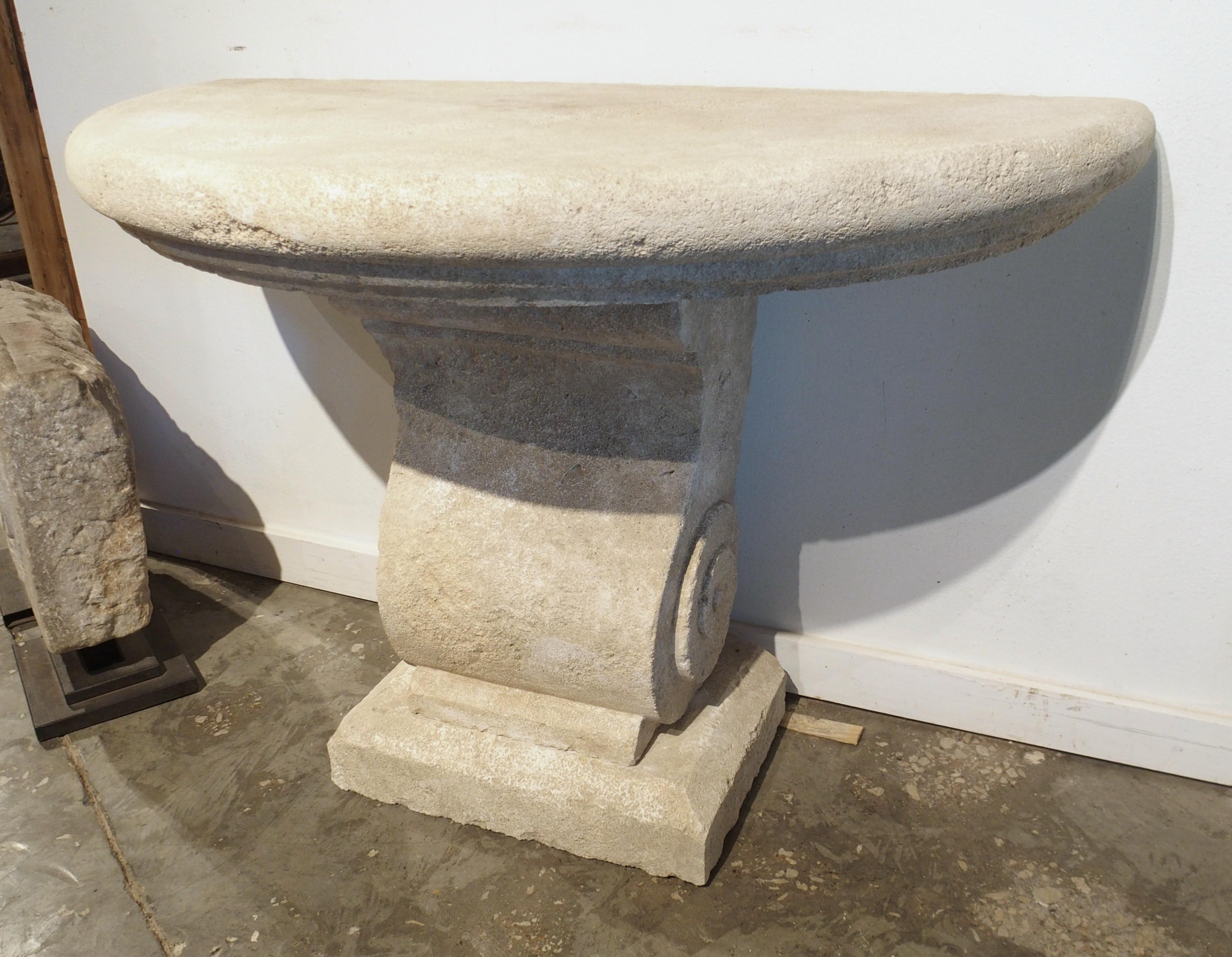 More information coming soon…

A charming demi-lune console table, hand-carved in limestone in the South of France.  Composed of three sections of stone: a 4 1/2″ thick top with highly recessed step molding, a scrolled support adorned with tight