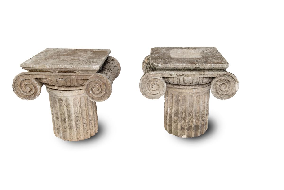 Carved limestone ionic side tables or pedestals being sold separately.