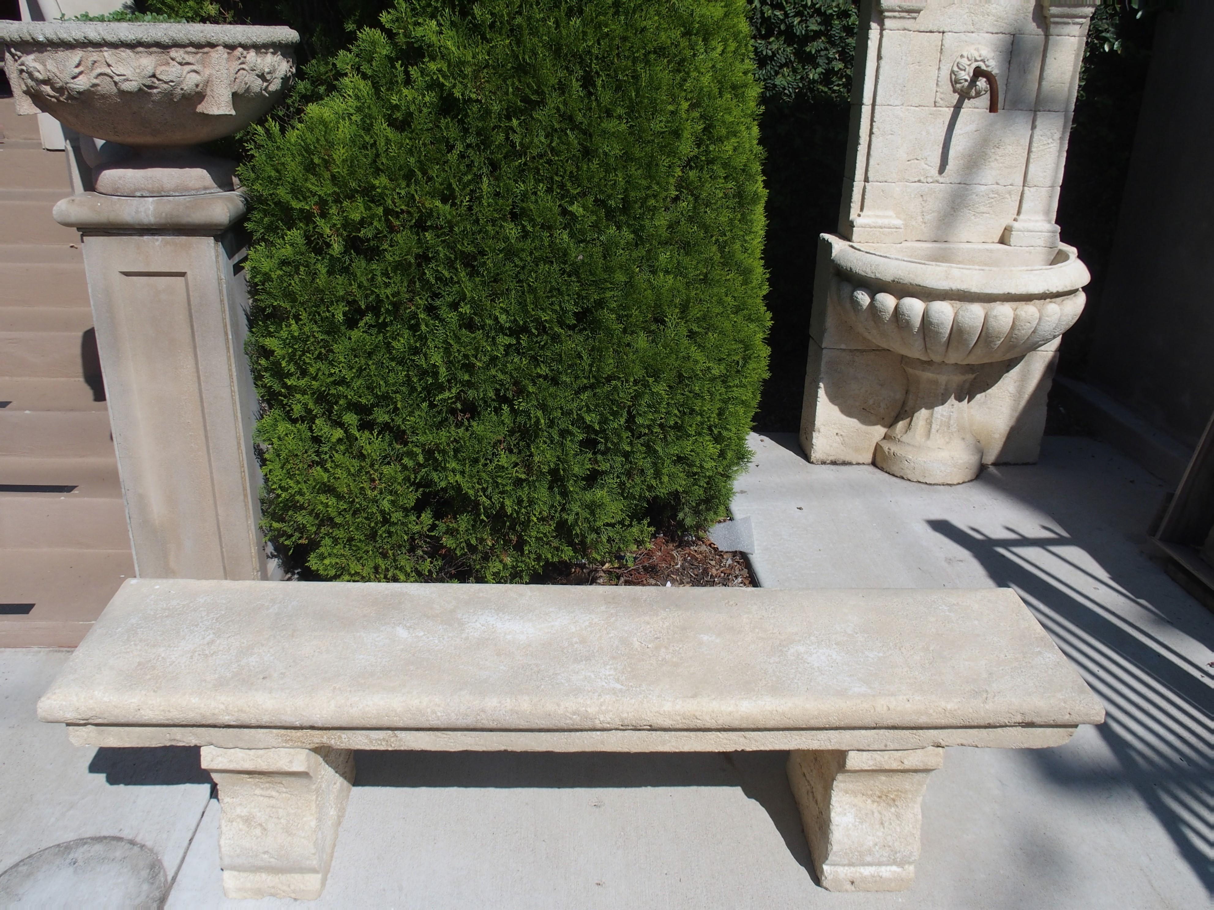 This classic hand carved limestone park bench is from Provence, France. The seat is one solid stepped in piece of stone that rests upon two shaped block feet. The upper seat area is a rounded molding (done by hand). Perfect for placing with a table