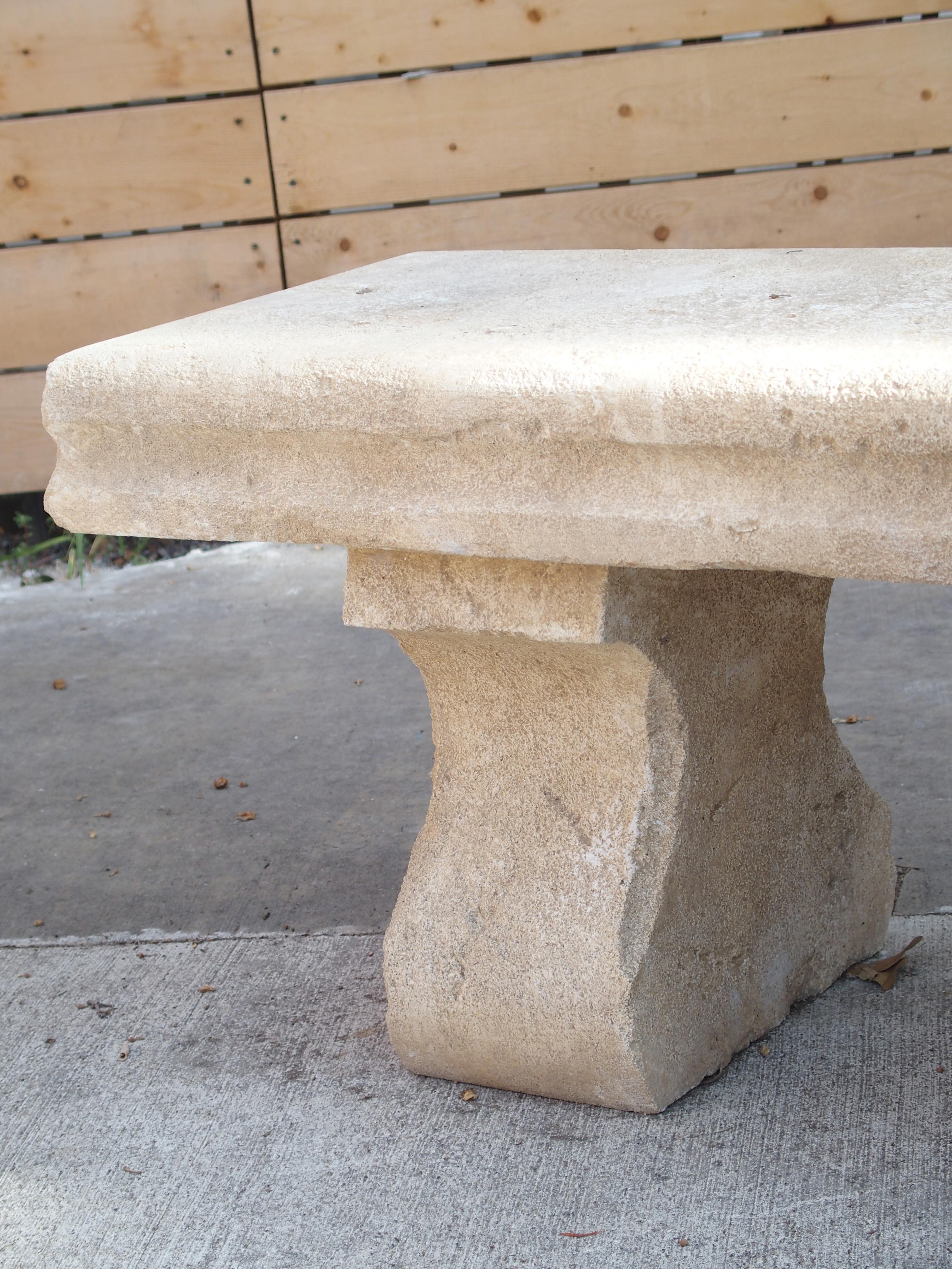 Hand-carved in the South of France, this limestone villa bench rests upon two shaped legs. The lovely cream color stone measures 4 ¾ inches thick and has white accents. A recessed cavetto edge embellishes the rectangular seat on all four sides.