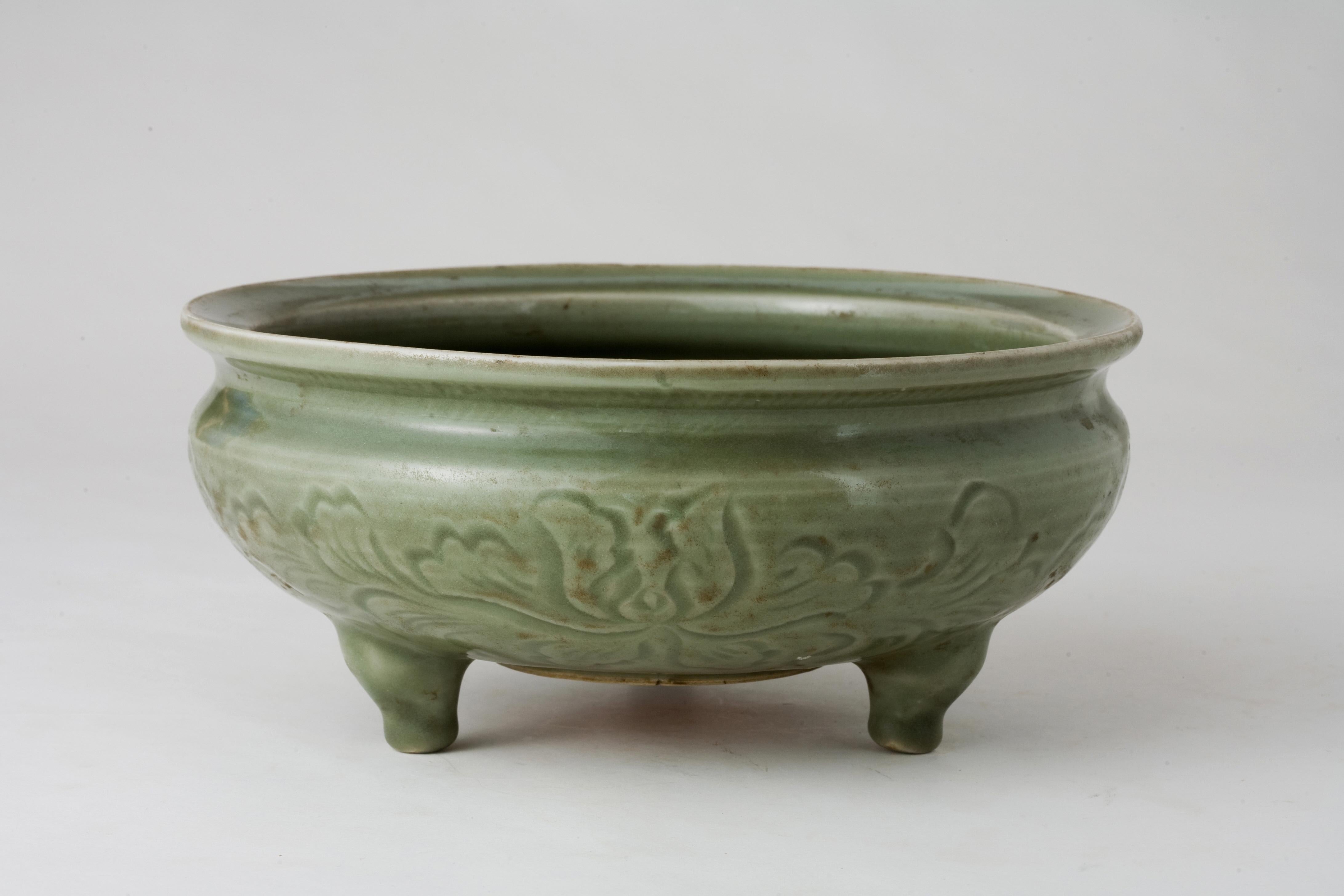 This censer is characterized by its tripod form, which means it stands on three feet. Incense burners from the Ming dynasty are often highly regarded for their craftsmanship and the quality of the glaze texture and coloration. This piece features