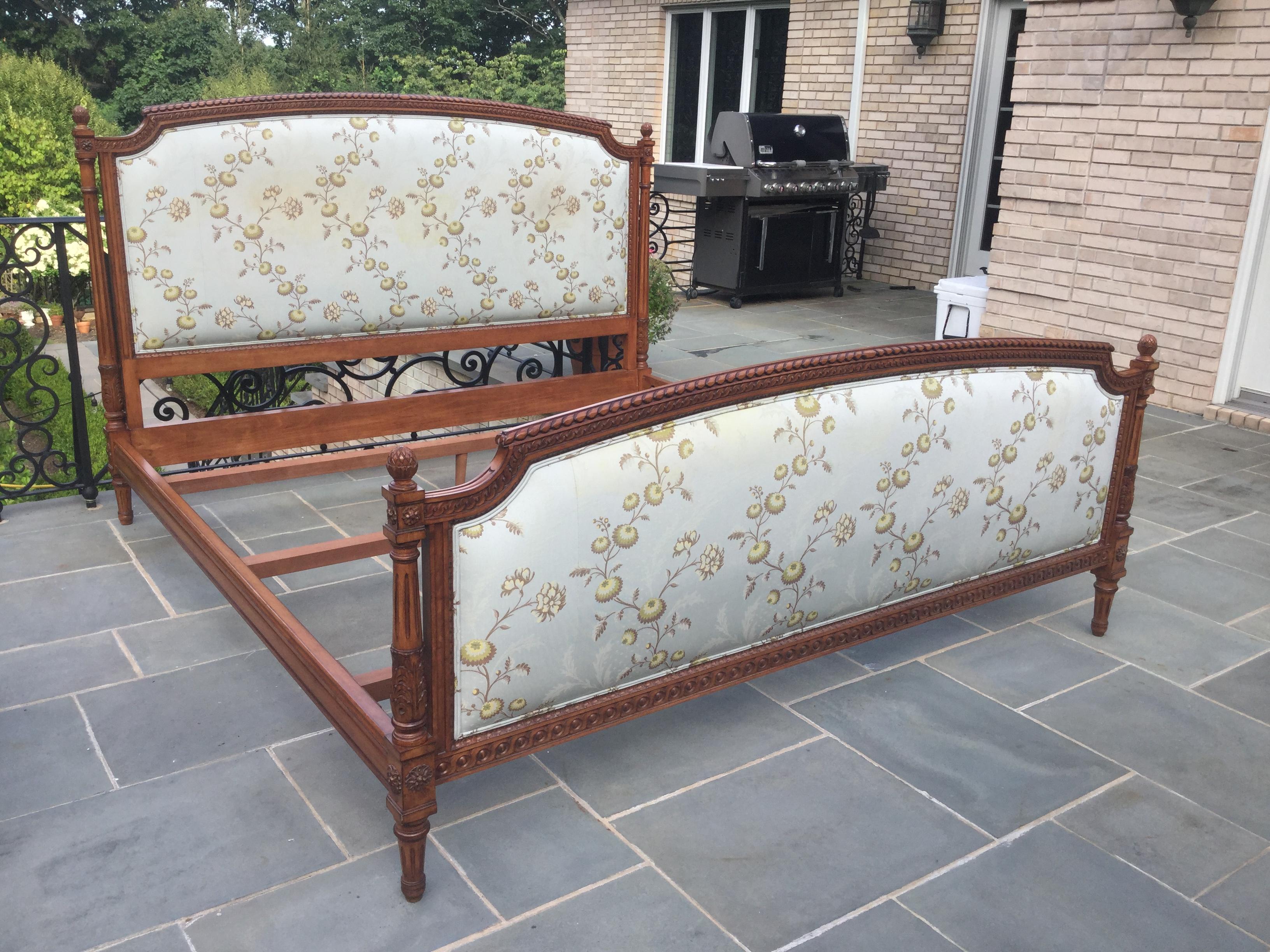 You will love this beautifully carved Louis XVI style King-size bed. This bed features the original Scalamandre upholstery, however there is some yellowing on the fabric. We are selling the bed in its current condition, giving the buyer the option
