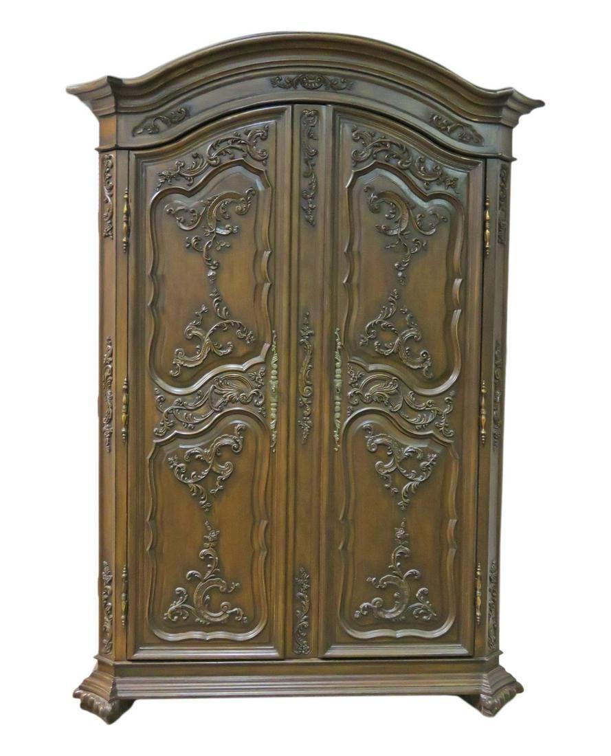 This is an absolutely gorgeous carved mahogany armoire. Attributed to Ralph Lauren this armoire is not labeled but definitely looks like his collction and has that level of quality. The armoire is in good used condition and dates to the 1990s era.