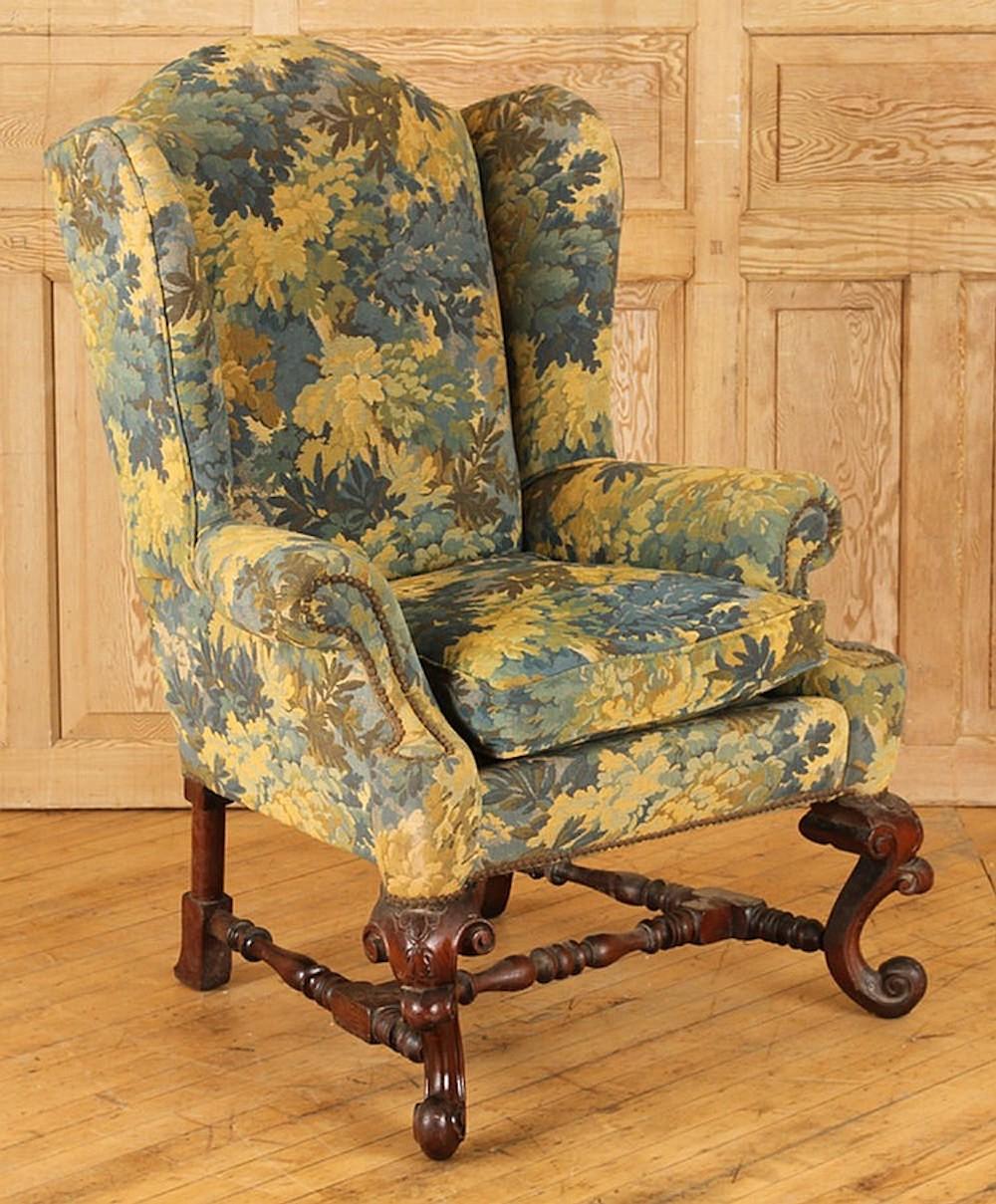 A carved mahogany Baroque upholstered wing chair, circa 1890.