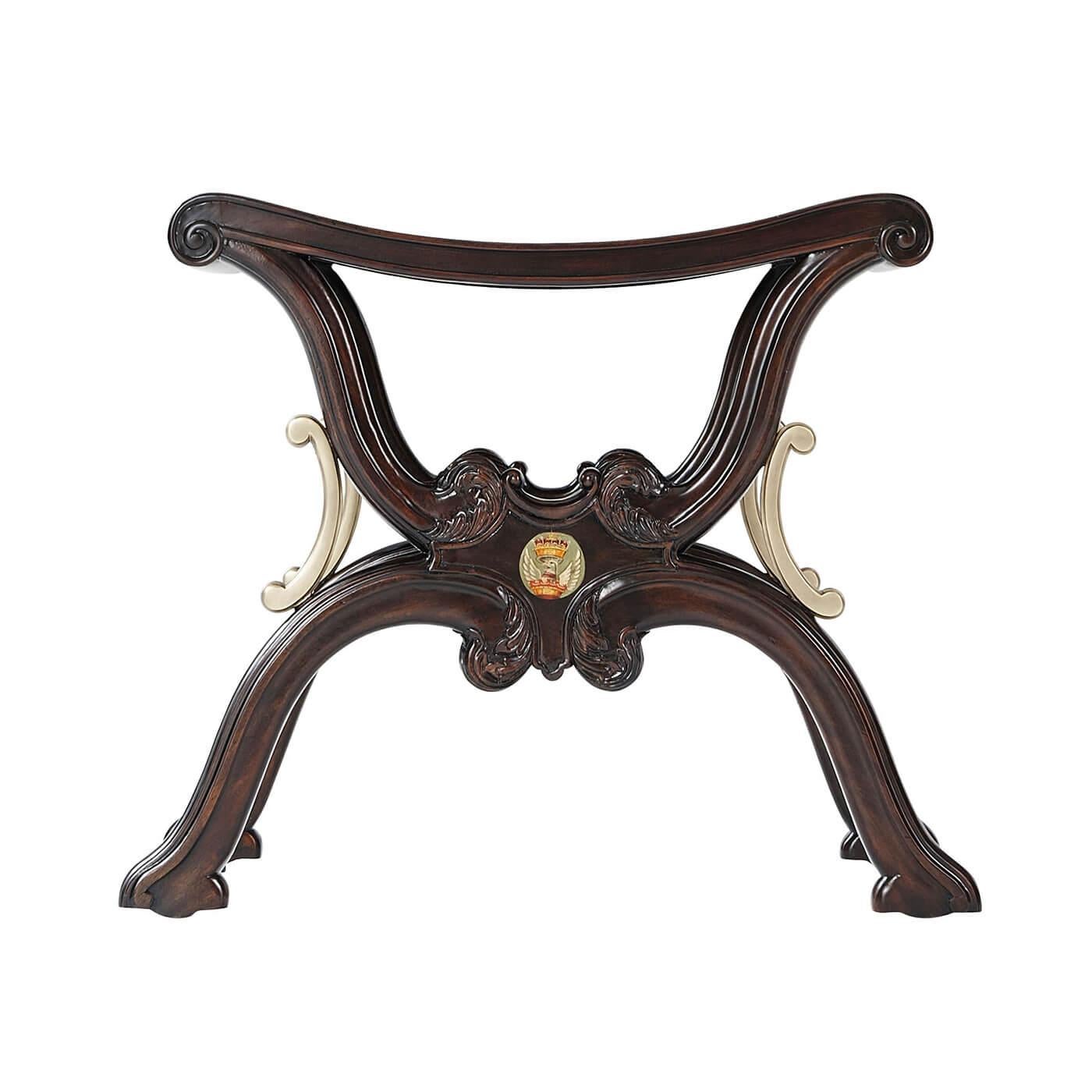 A carved Chippendale style mahogany X frame hall stool in the manner of Gillows of Lancaster, the bowed molded edge solid seat on serpentine carved 