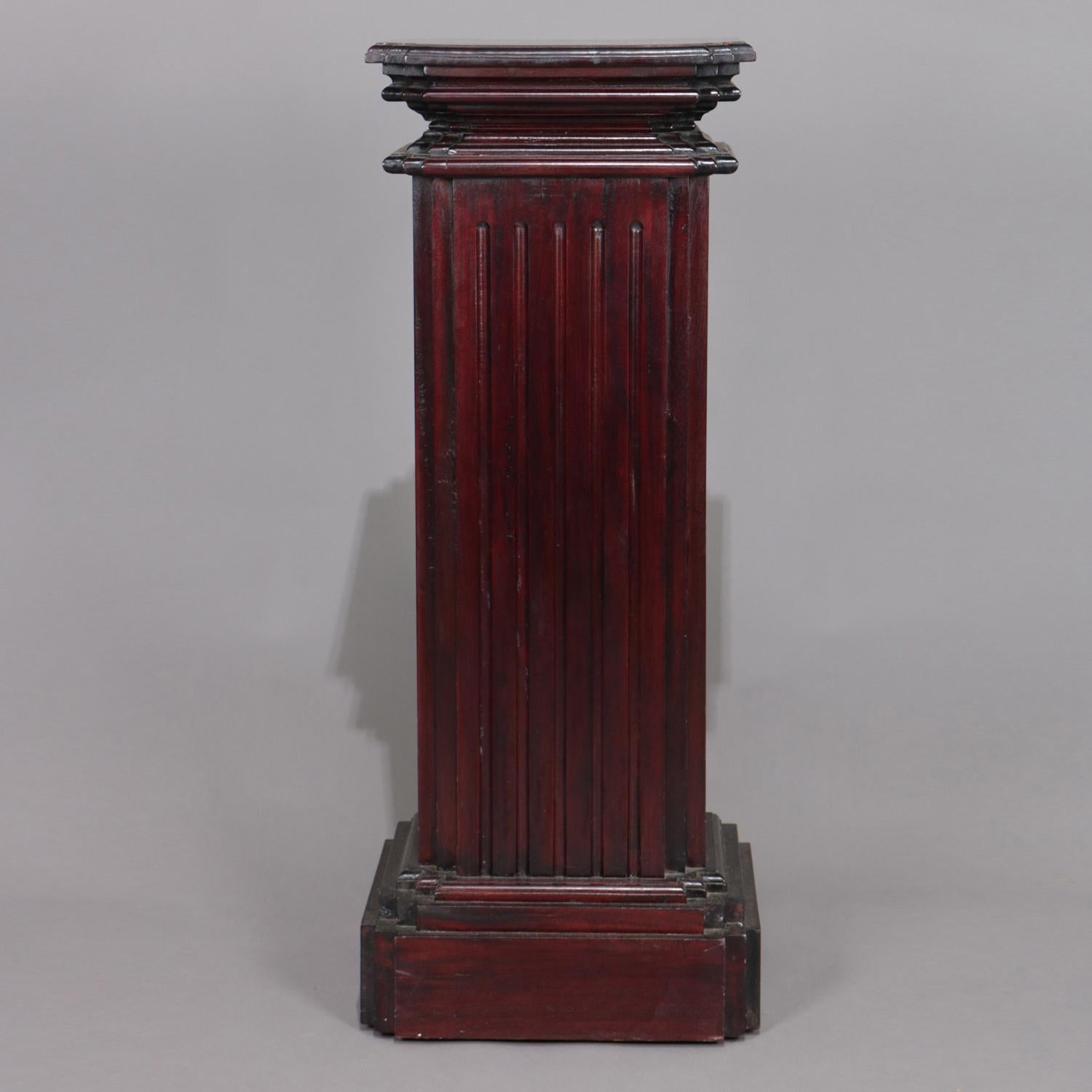 Corinthian column sculpture display stand features carved mahogany construction in square from with stepped base and display and having reeded pedestal, 20th century

Measures: 37