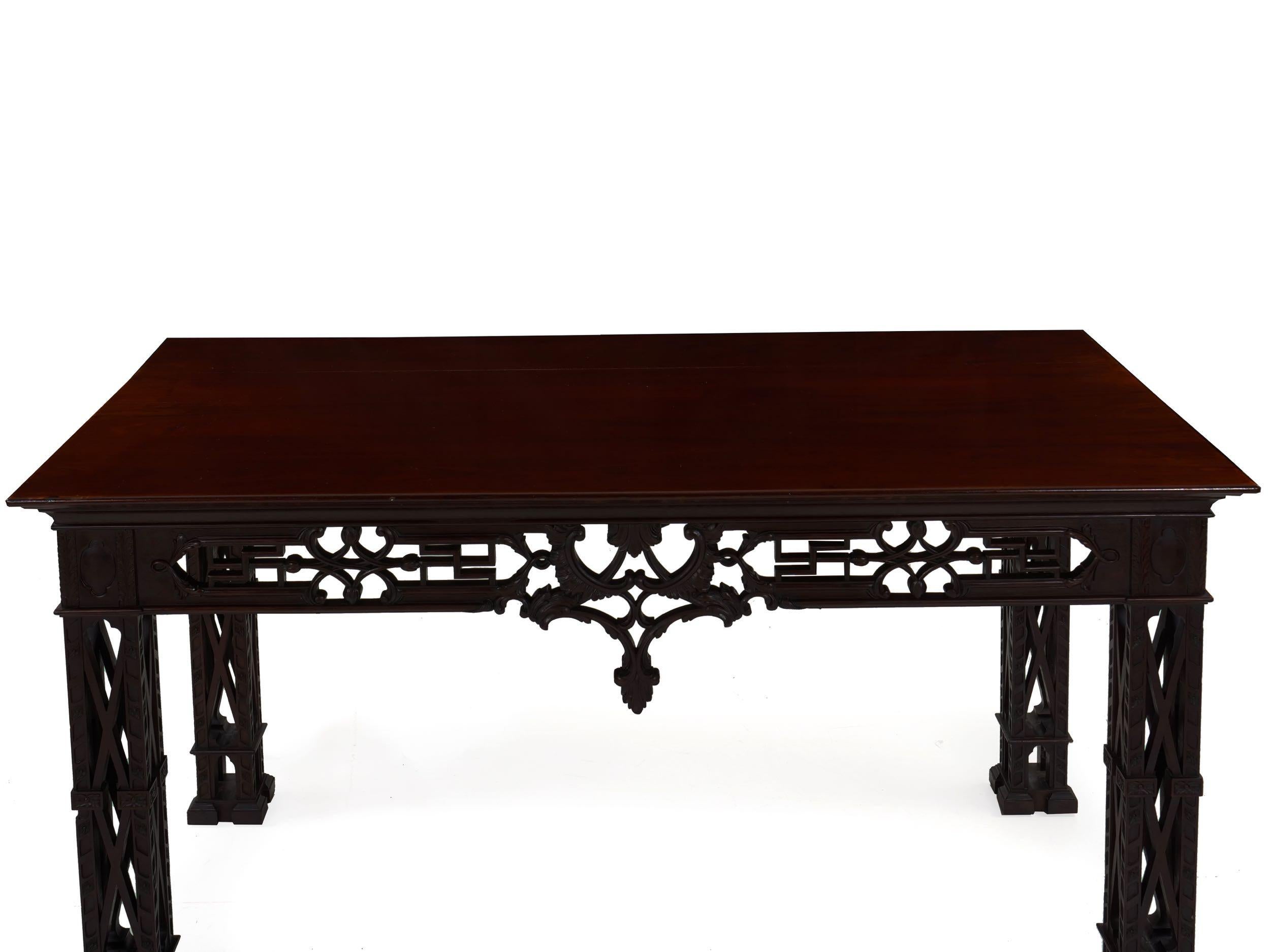A beautiful 20th century console table crafted in the manner of the George II forms, it is crafted entirely out of thick solid mahogany planks and finished in a polished deep ruby hue. The top is simple with a glowing patina and vibrant color. The