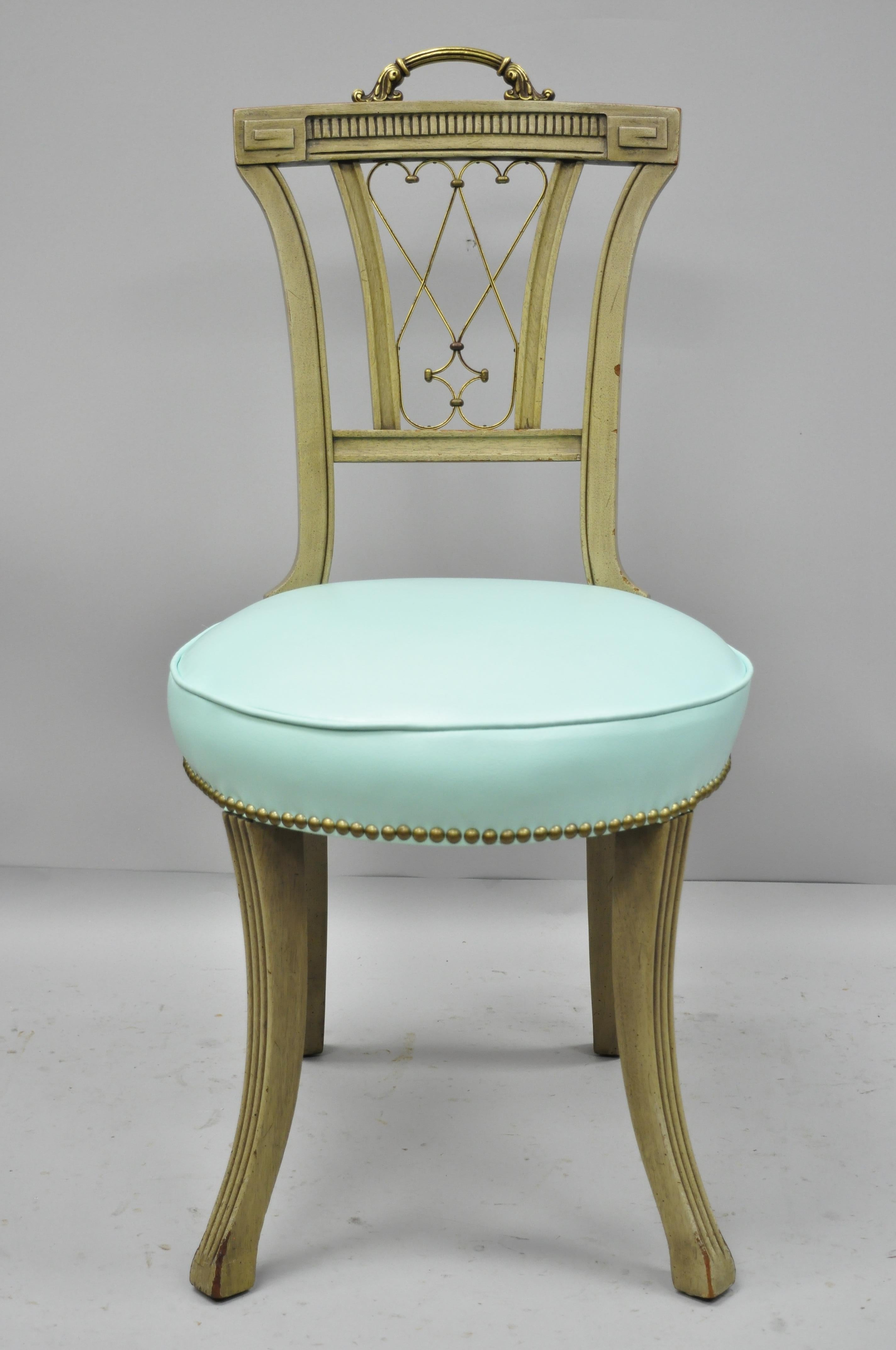 Carved mahogany French Regency style chair with brass handle and aqua blue vinyl. Item features ornate brass handle, brass decorated 