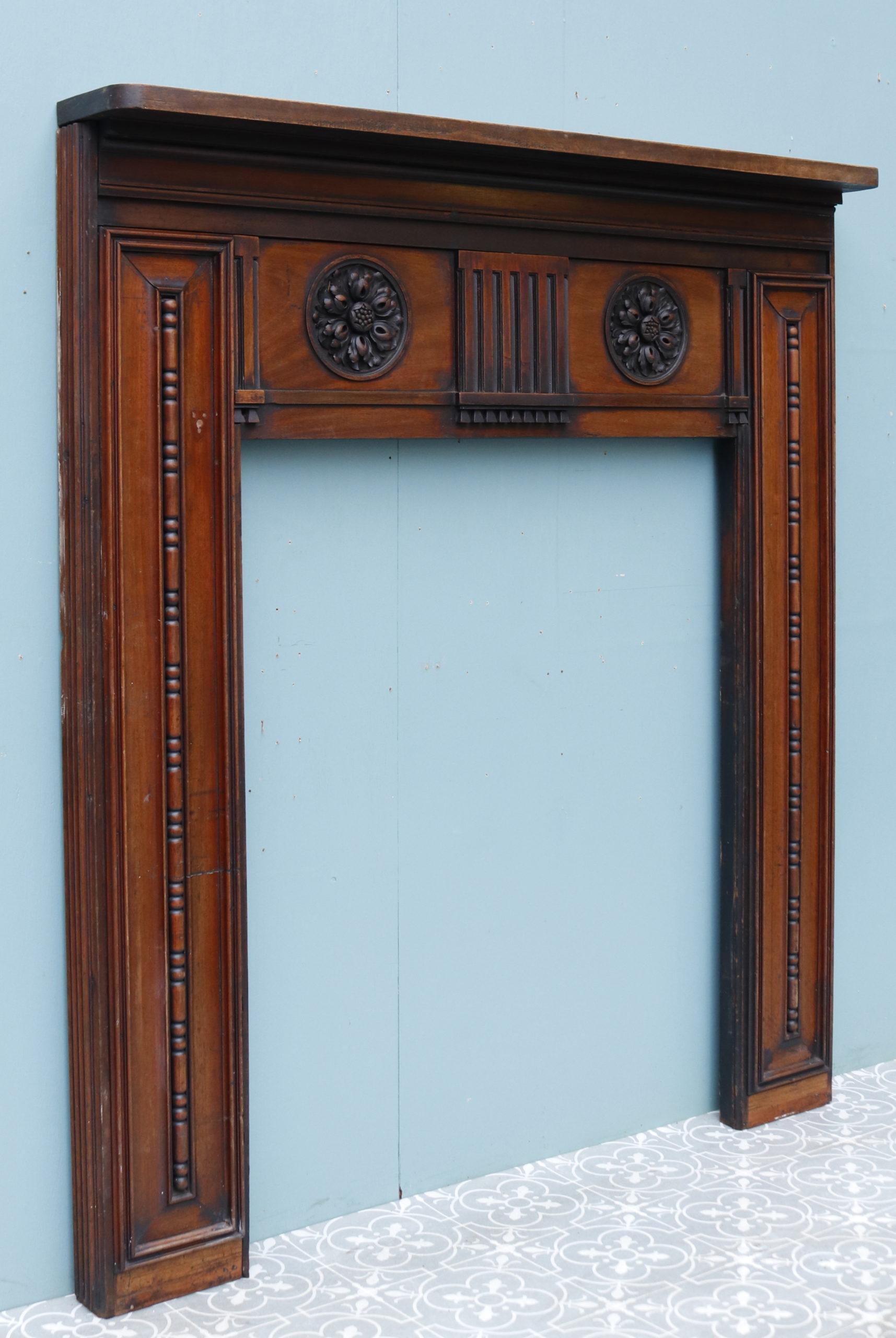 A reclaimed early 19th century Georgian style carved Mahogany fireplace.

Additional Dimensions:

Opening Height 97 cm

Opening Width 97 cm

Width between outsides of the foot blocks 119.5 cm.