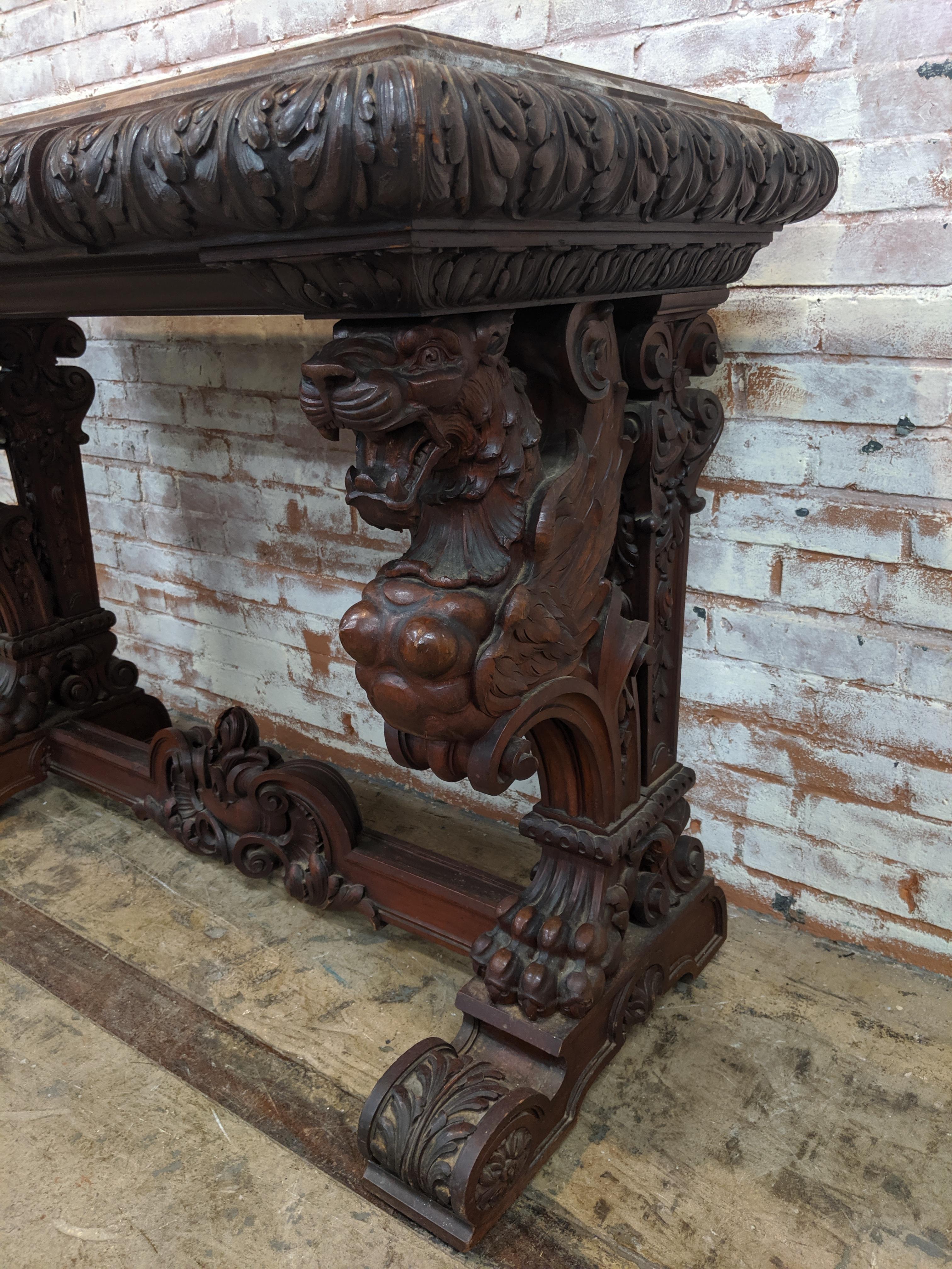 Unique mahogany 19th century console table with carved griffins. Awesome pierced carved griffins on either side of this piece with great original patina. Top of console needs refinishing but piece is otherwise a great example of 19th century