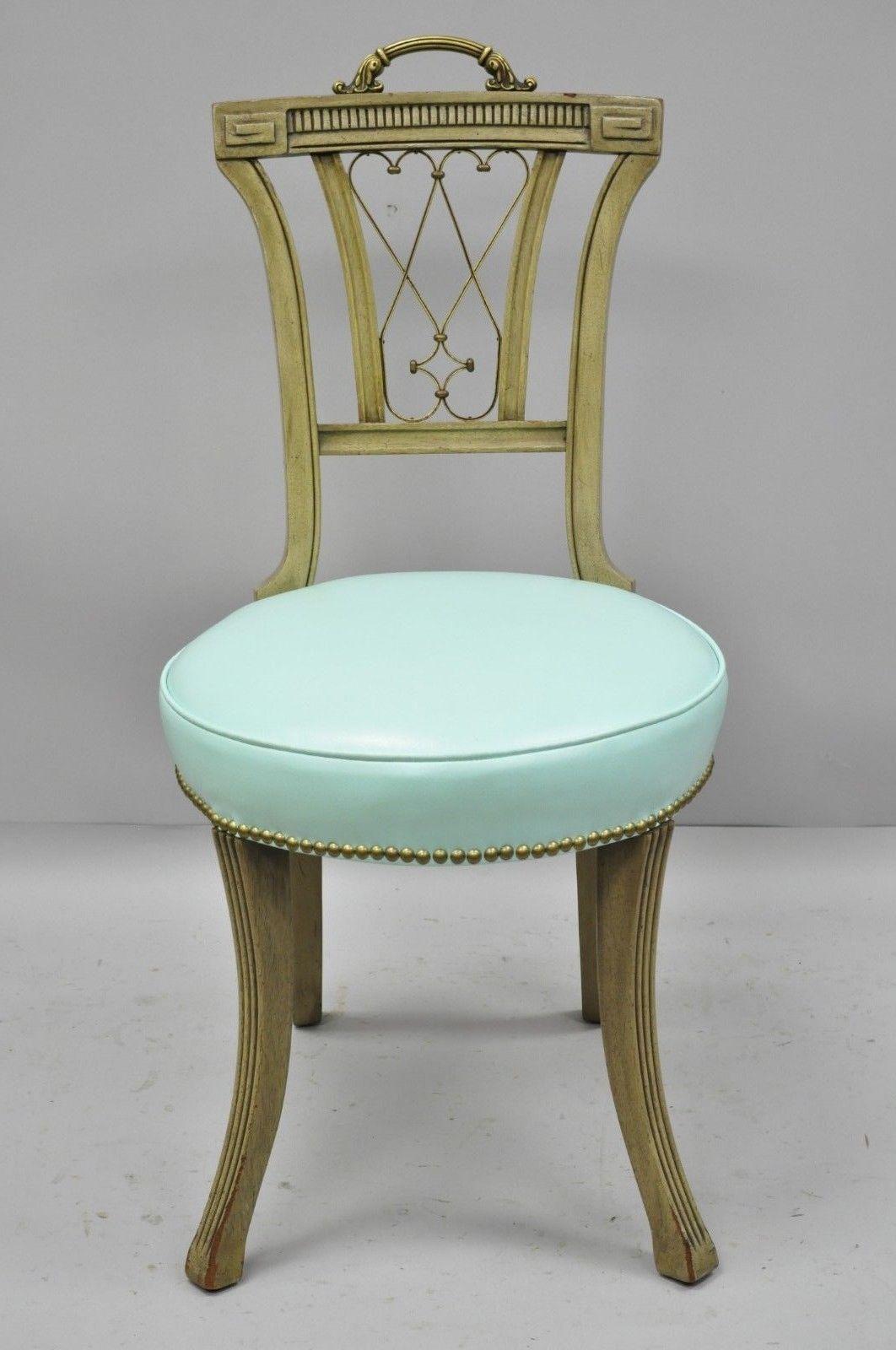 Carved mahogany French Regency style chair with brass handle and aqua blue vinyl (B). Item features ornate brass handle, brass decorated 