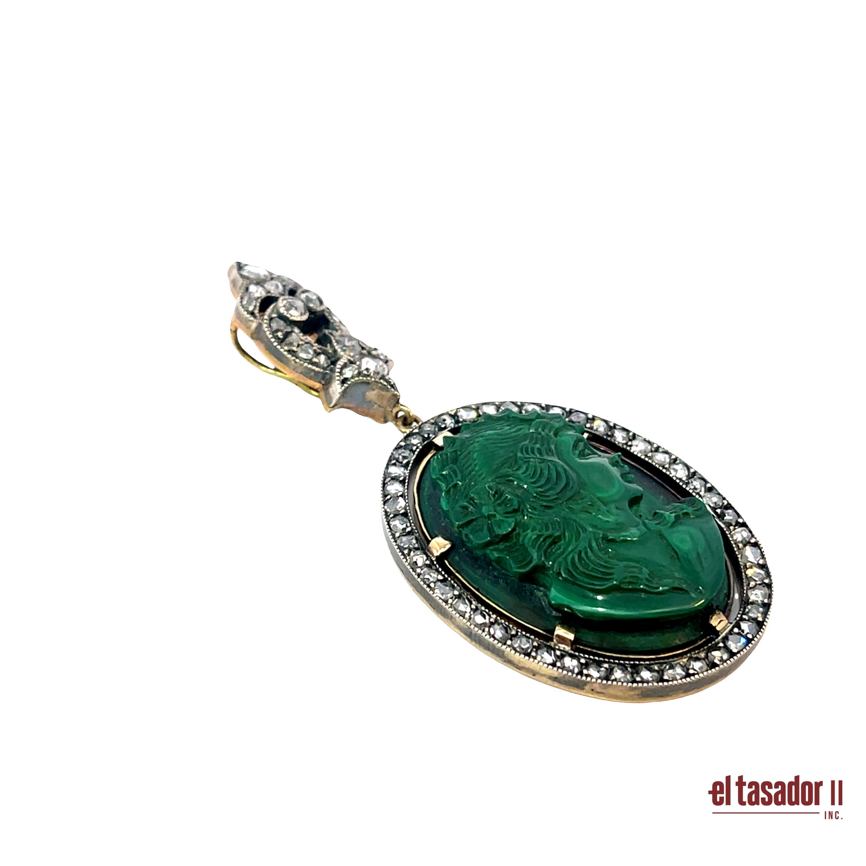 This exquisite pendant showcases a finely carved malachite cameo, depicting a classical profile rich in detail and depth. Weighing 18.5 grams, it is crafted in a sophisticated combination of gold and silver, lending it a timeless, antique-inspired